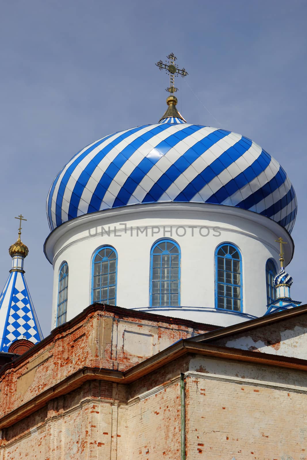 dome of the old church with crosses on sky background