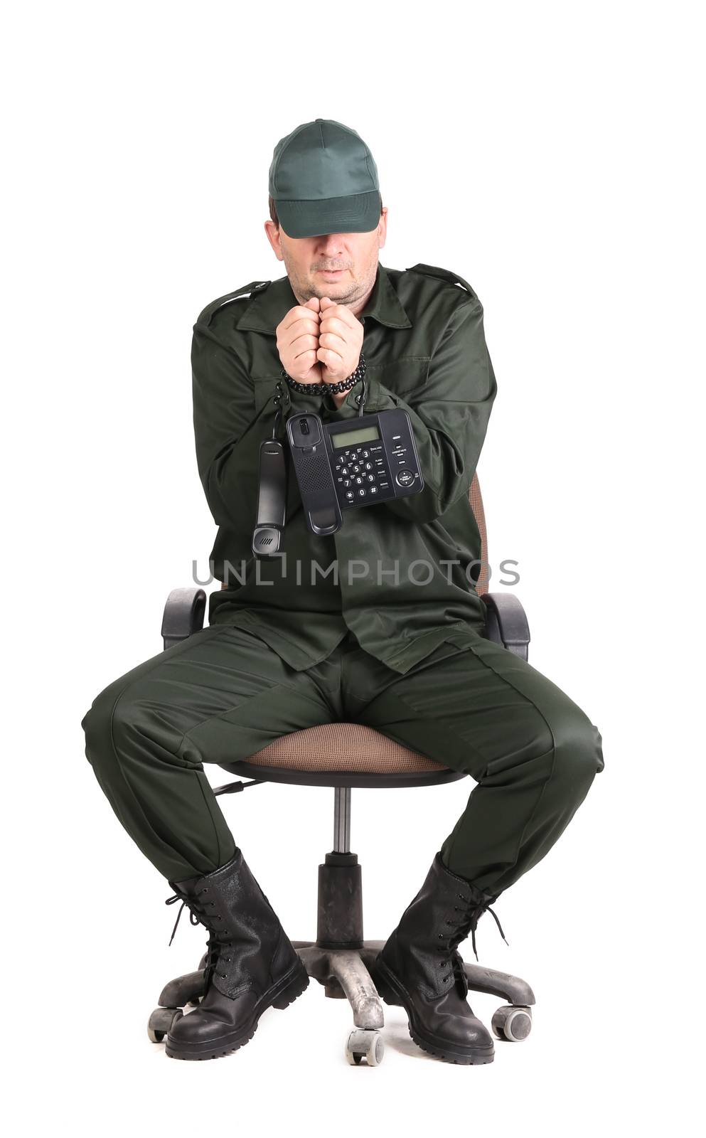 Man in workwear tied up with phone. Isolated on a white background.