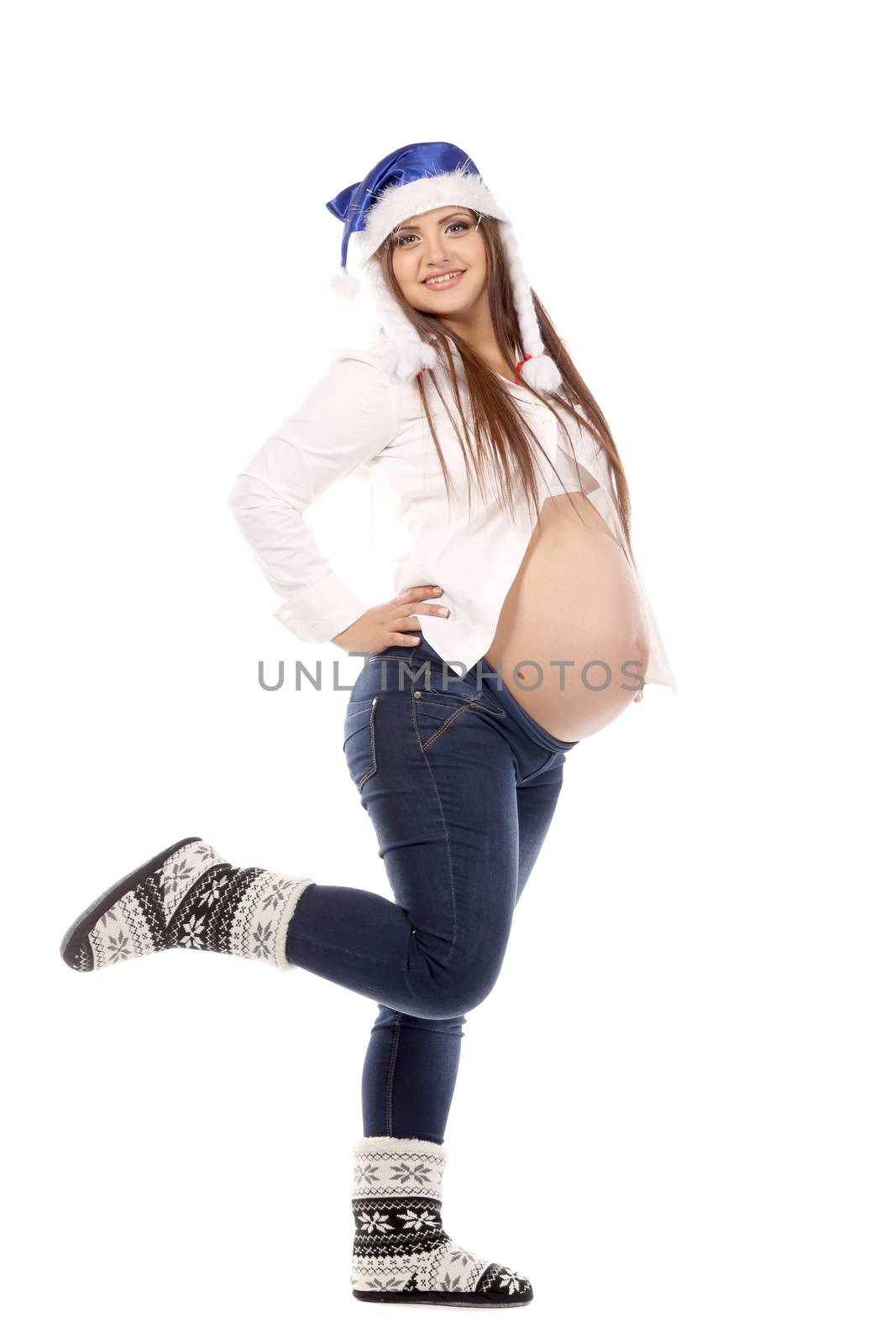 The pregnant girl in a New Year's cap. Isolated on a white background.