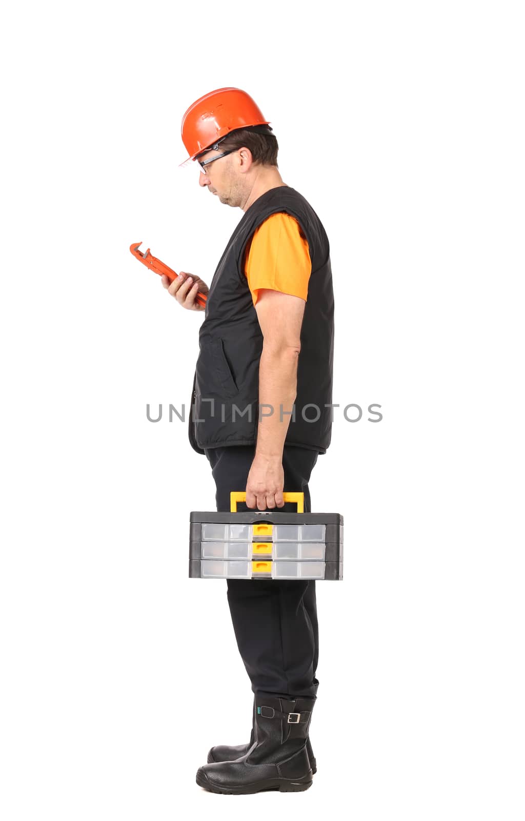 Man in red hard hat looking at wrench. Isolated on a white background.