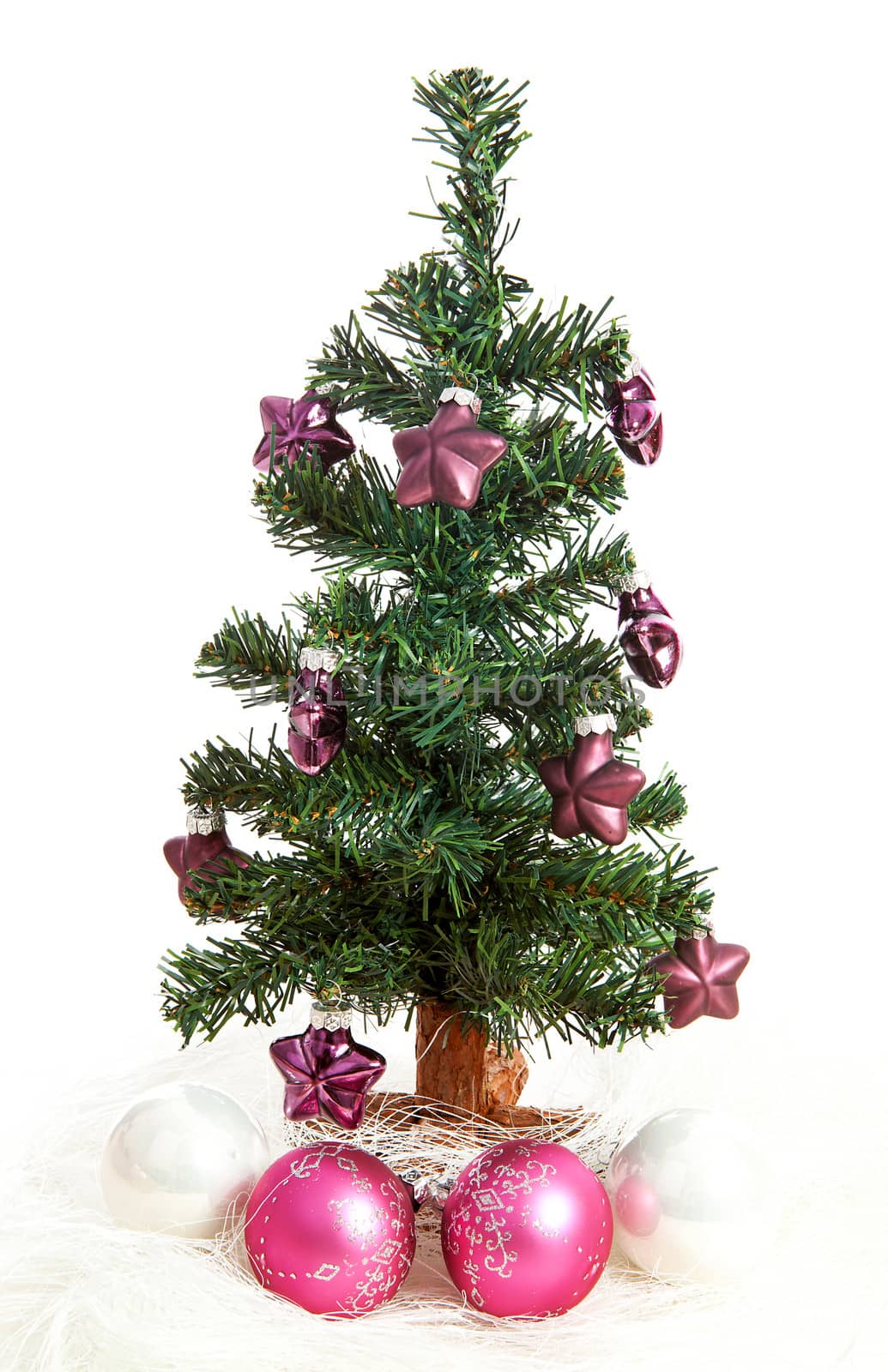 plastic christmas tree with purple stars and pink balls  isolated on white background