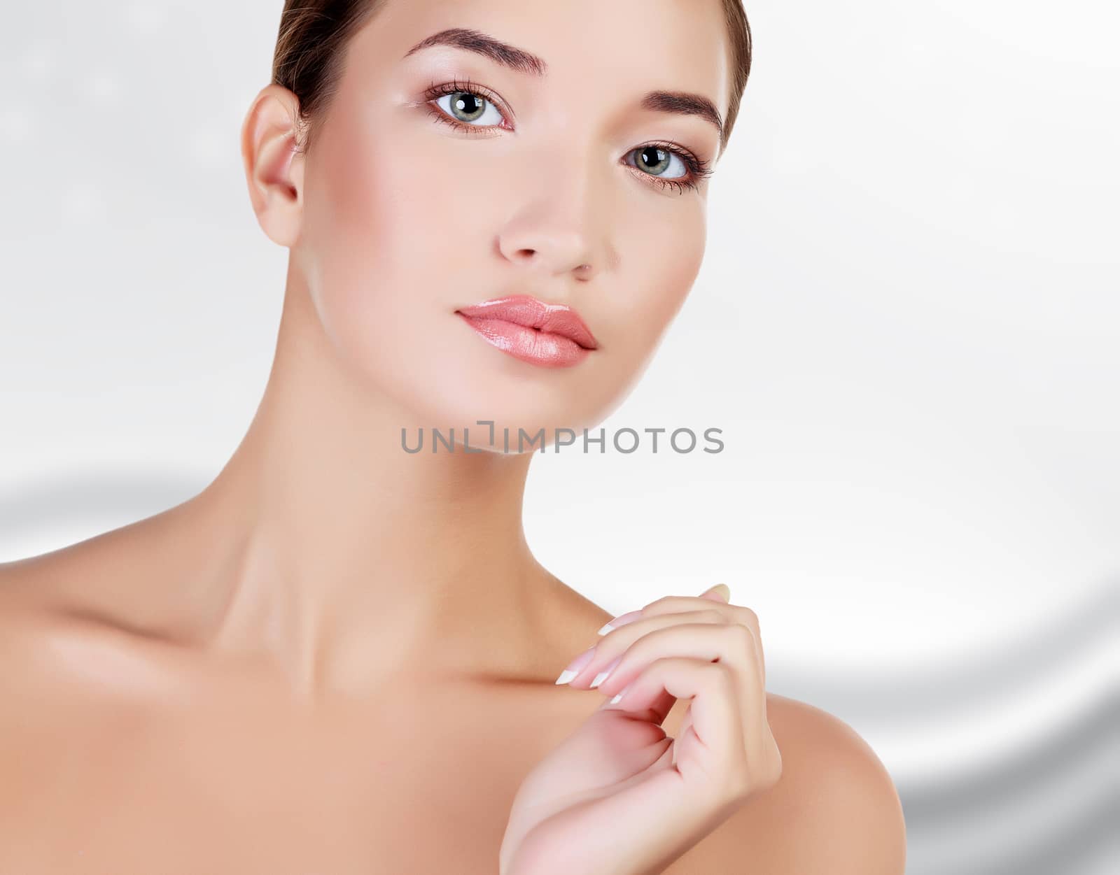 Beautiful asian girl with clean fresh skin, abstract grey background