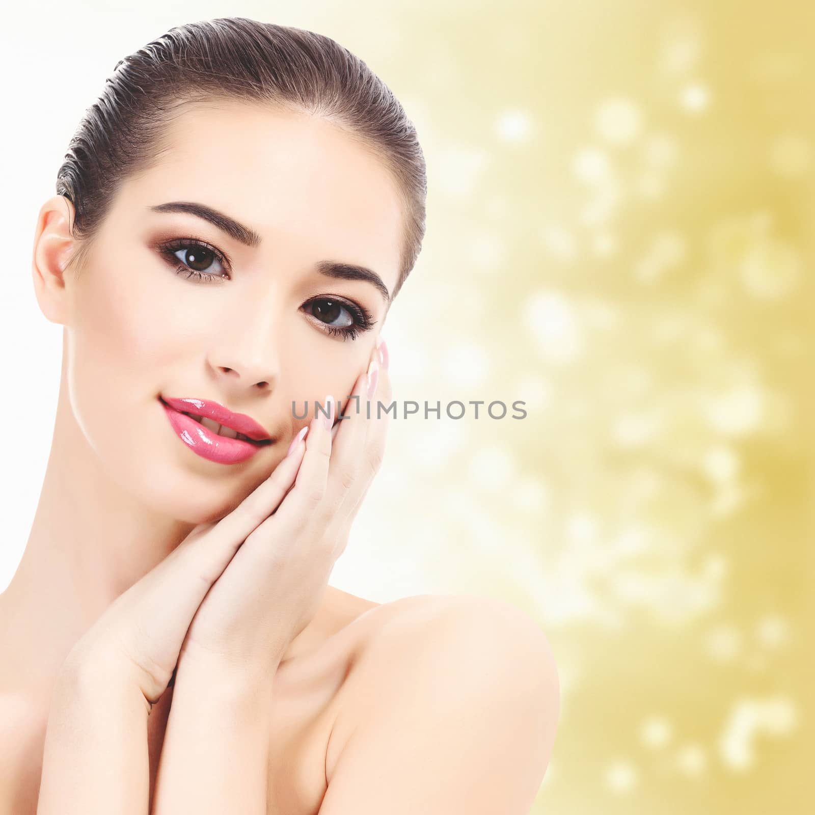 Beautiful girl with clean fresh skin, yellow background with blurred lights