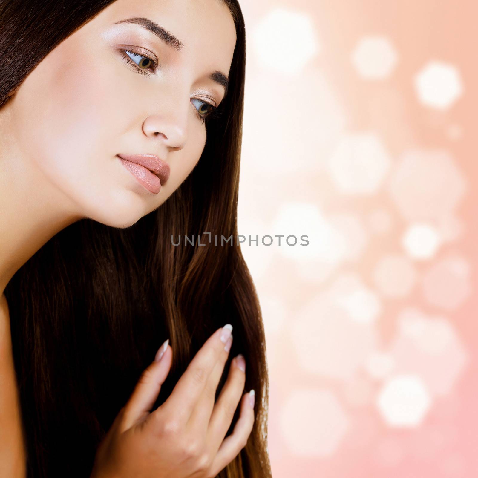 woman with long dark hair, blurred background