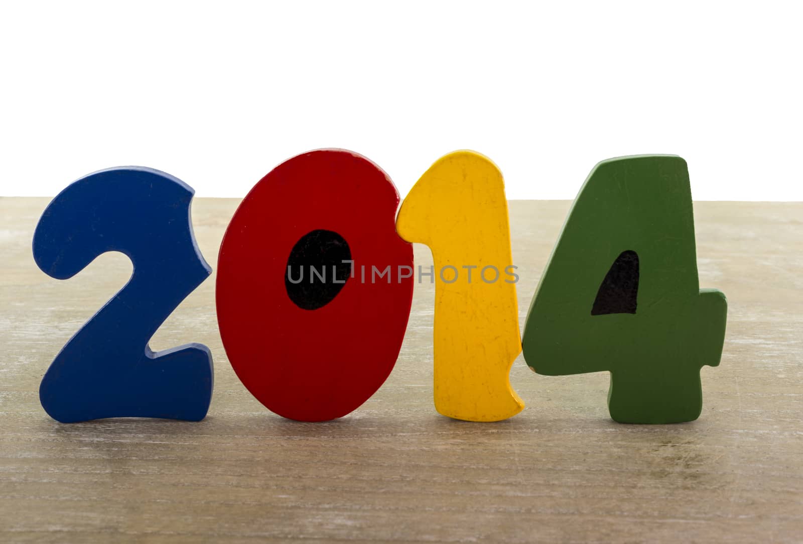 text new year 2014 in wooden letters blue red green yellow on wooden plate