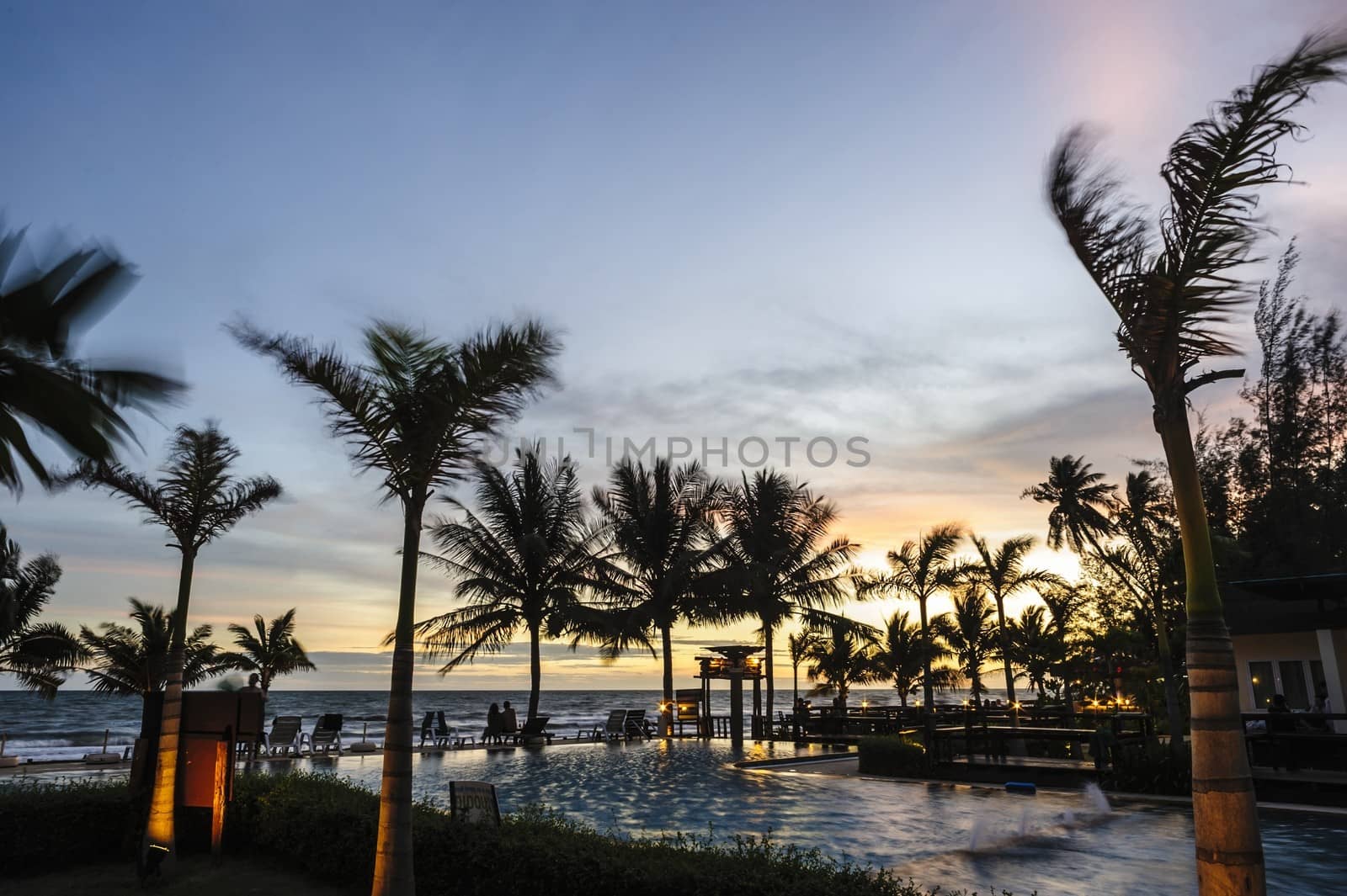 Twilight  hotel pool on the sea shore. by ngungfoto