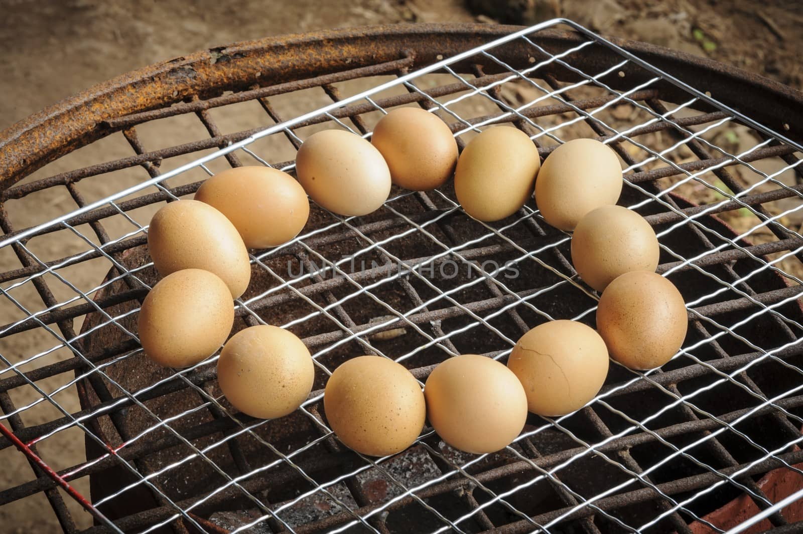 Chicken eggs Grilled over stove gridiron in local market.