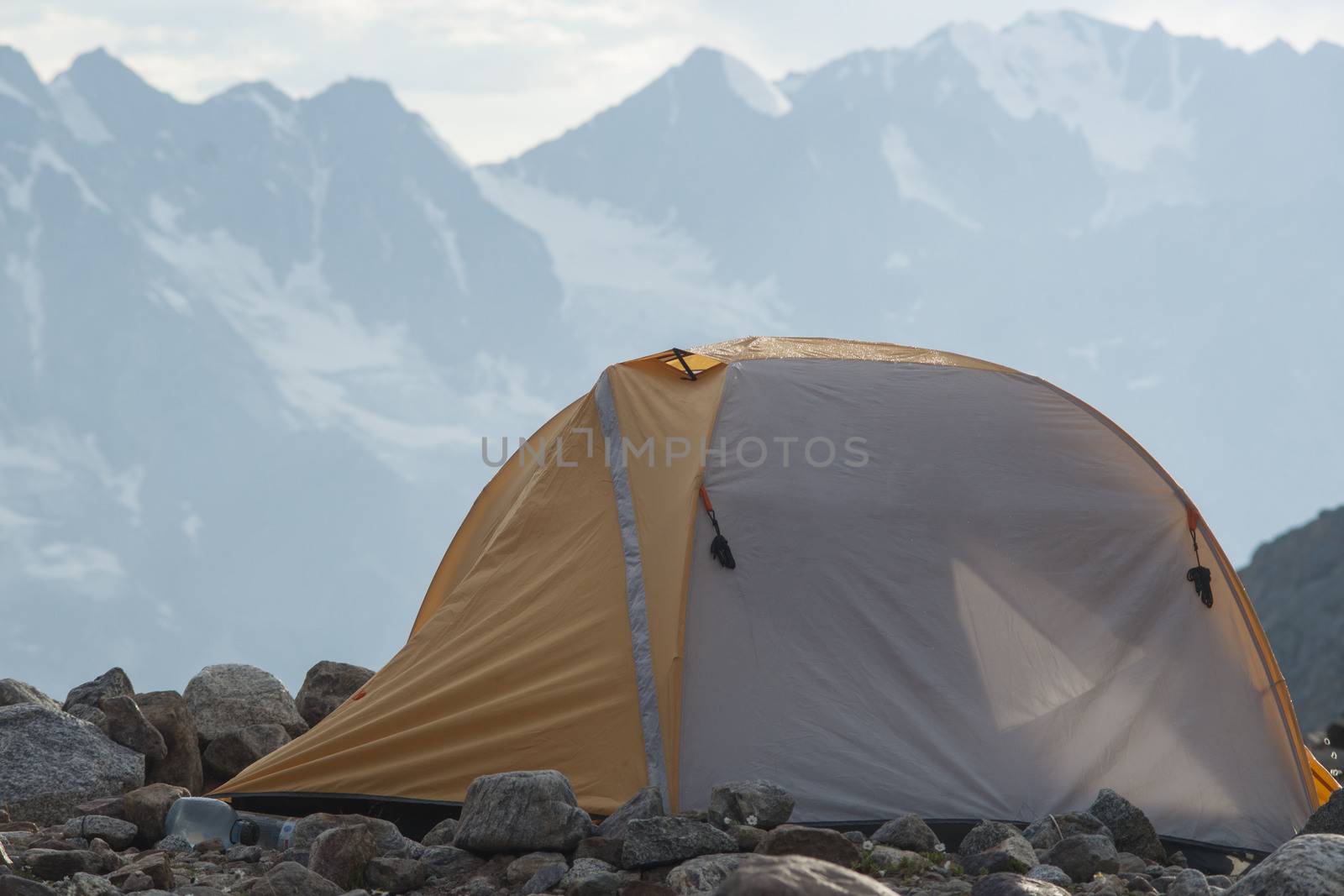 Gray and yellow tent in mountains
