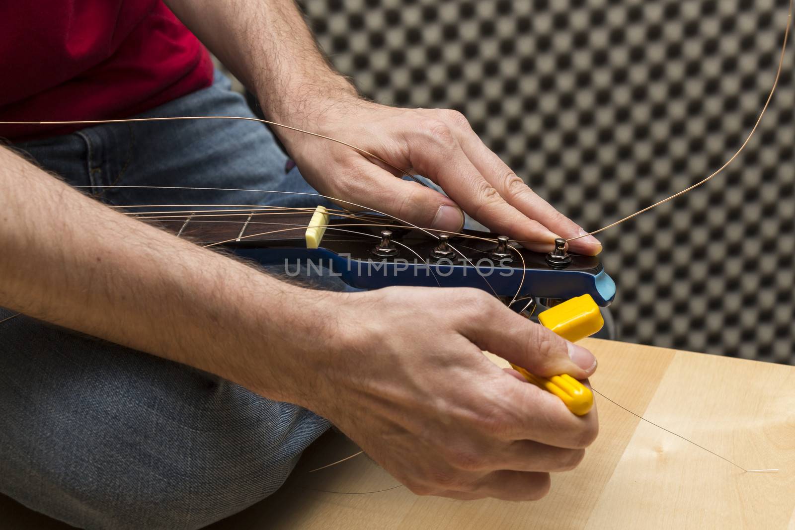 Guitarist using the string winder by snowwhite