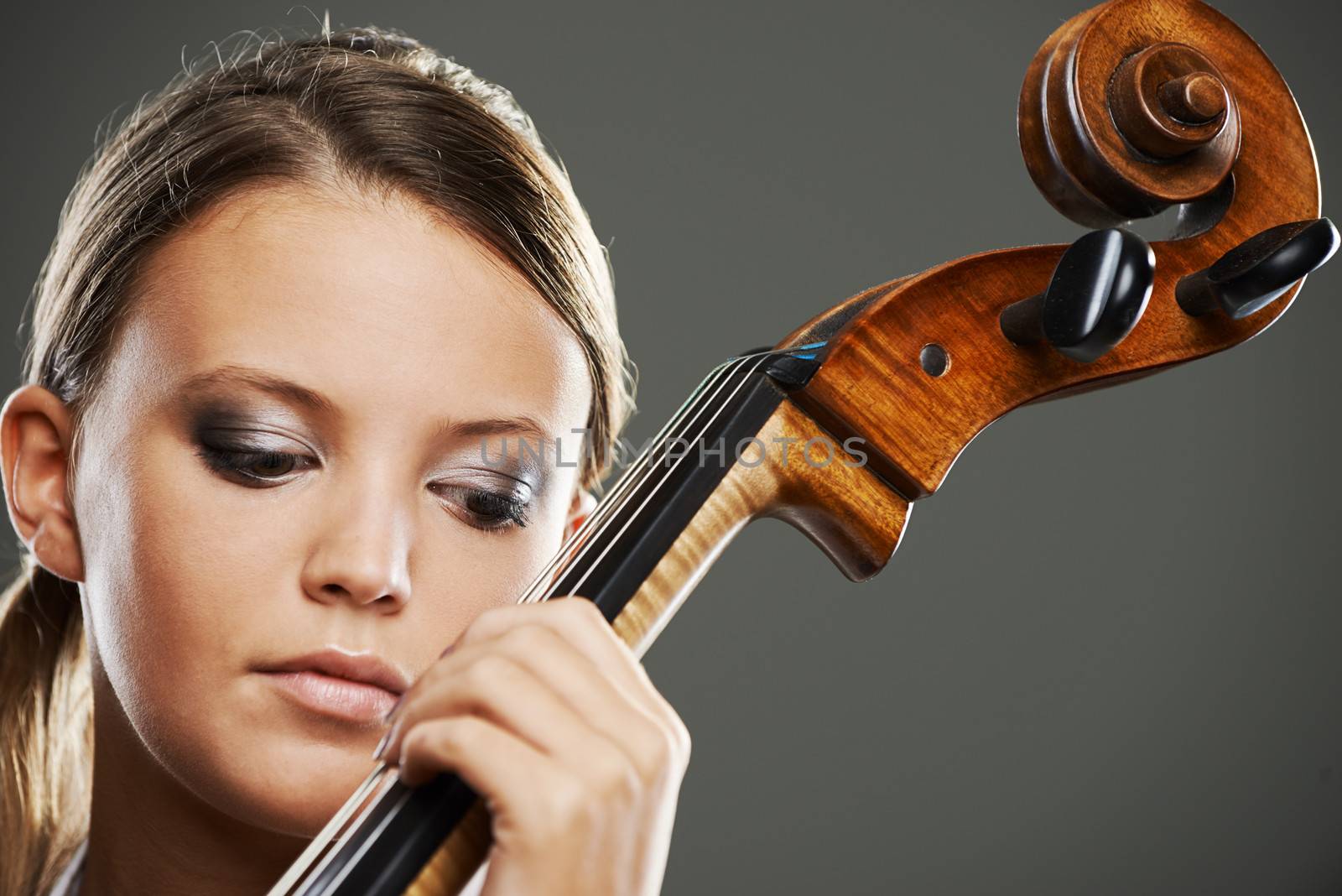 Close up portrait of a blond woman playing cello