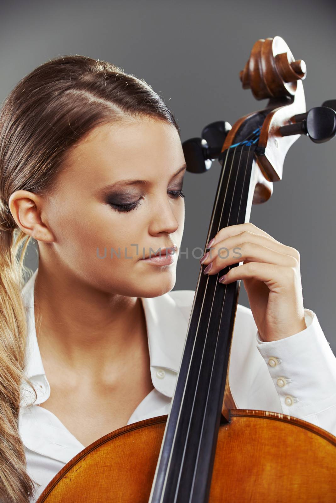 Close up portrait of a blond woman playing cello