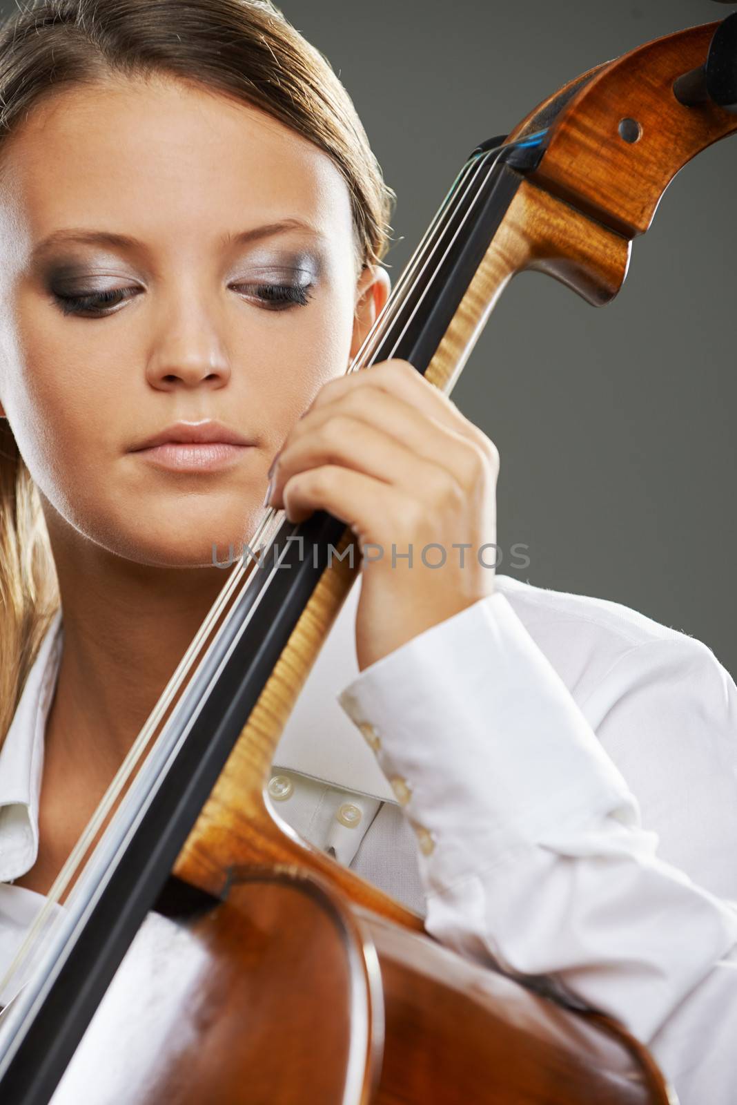 Close up portrait of a blond woman playing cello