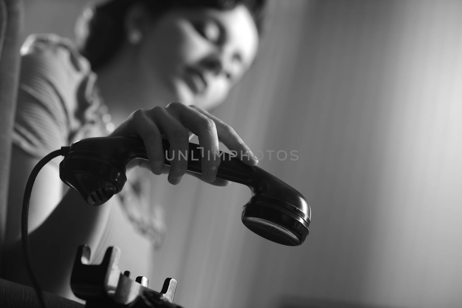 Woman with retro phone at home