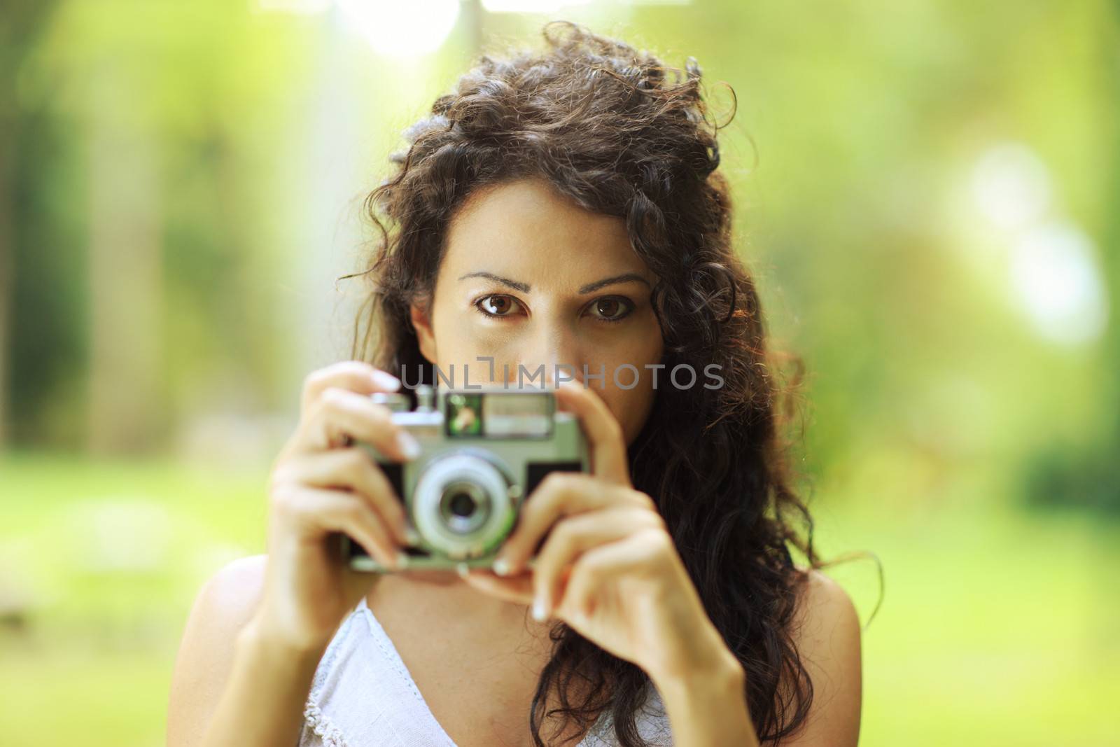 Portrait of an attractive young woman taking a photograph 