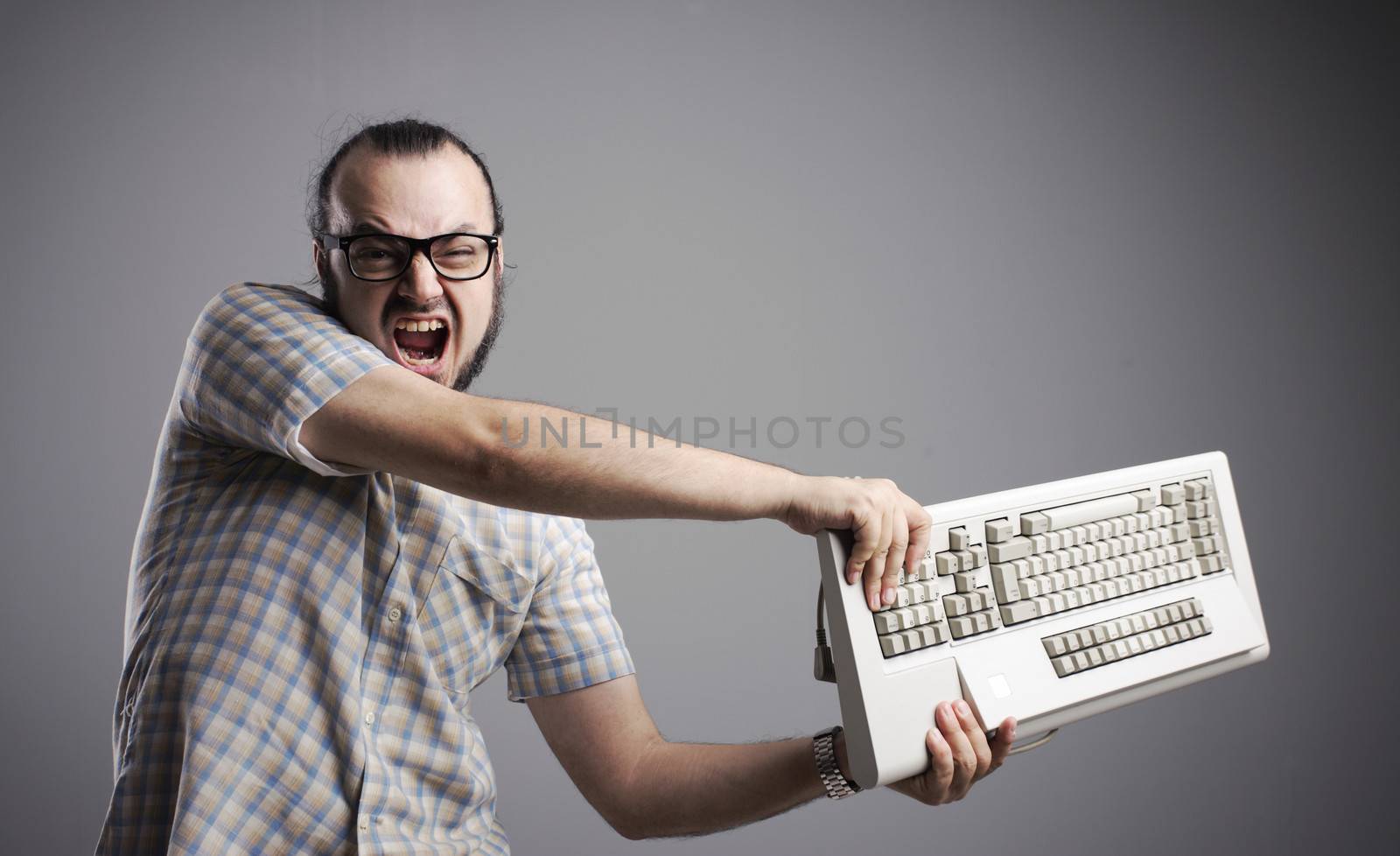 Angry man is destroying a keyboard