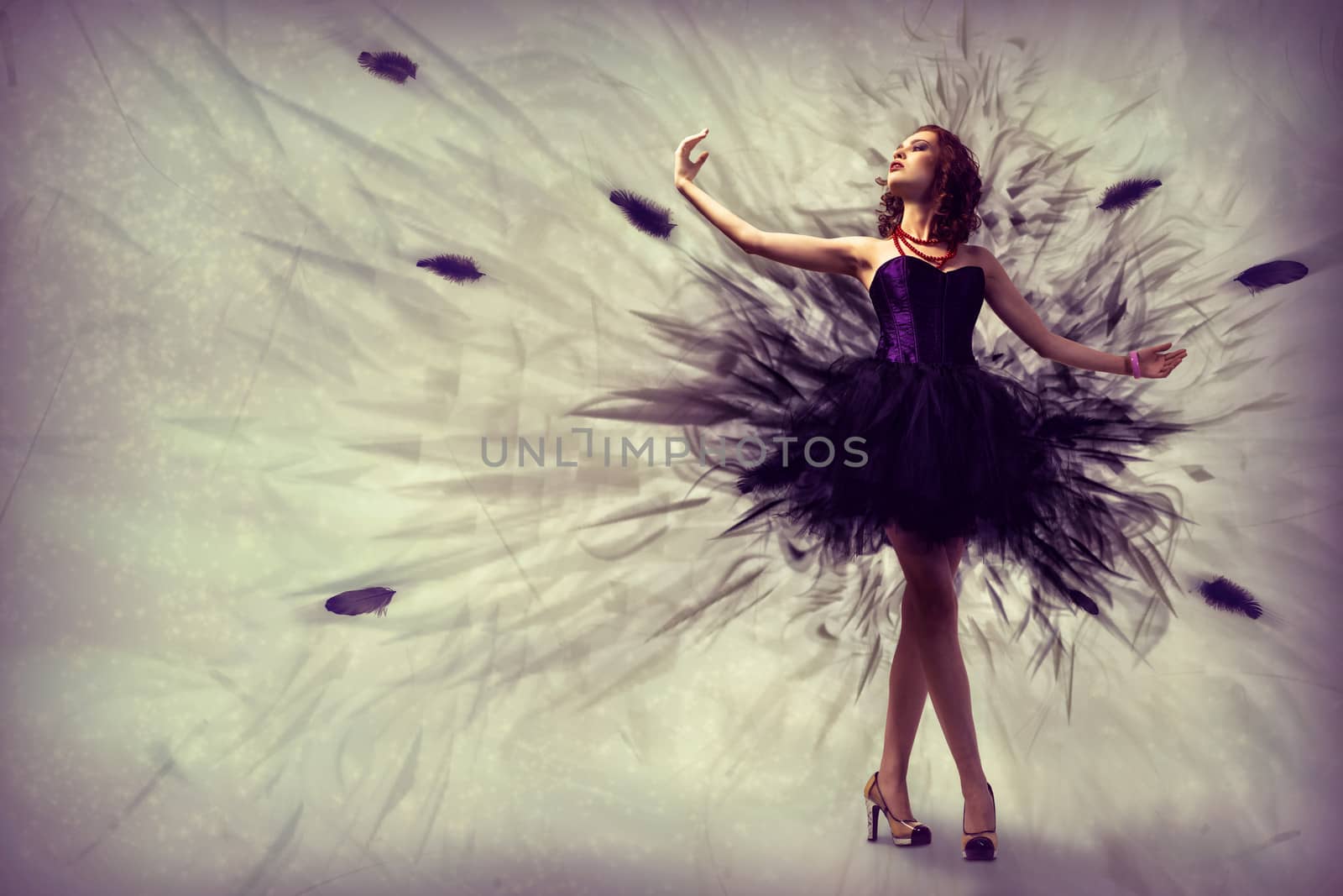 woman dancing in a dress made of smoke and feathers
