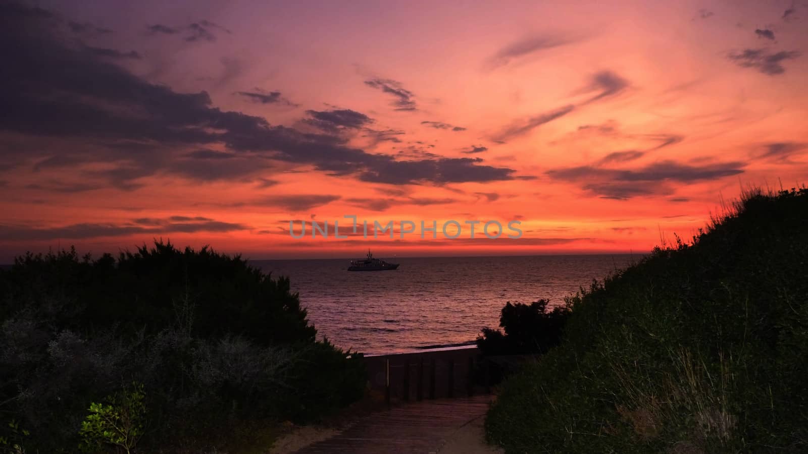 Sunset Sky at the Beach. A boat in the sea.