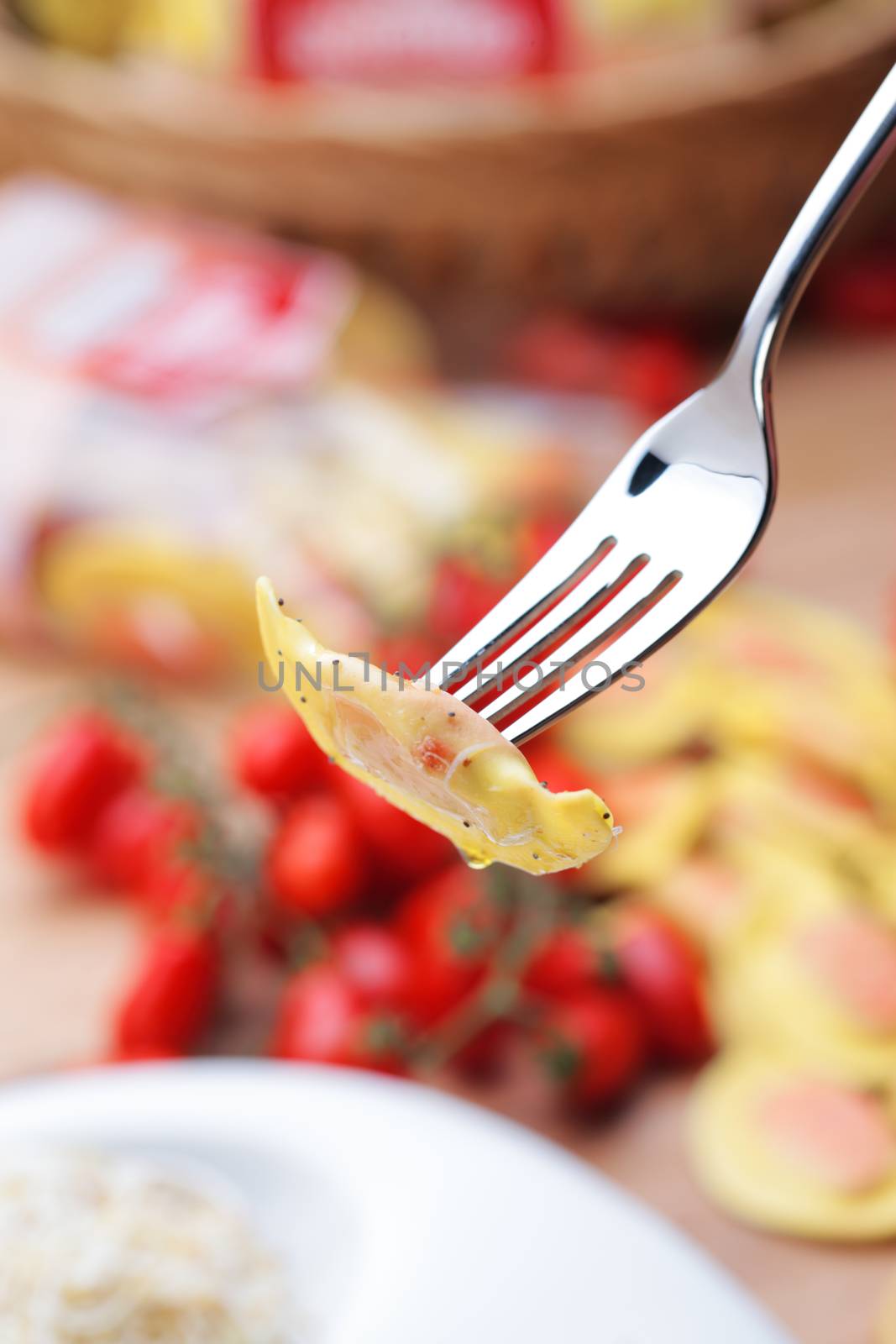 fork holds ravioli, close up shot