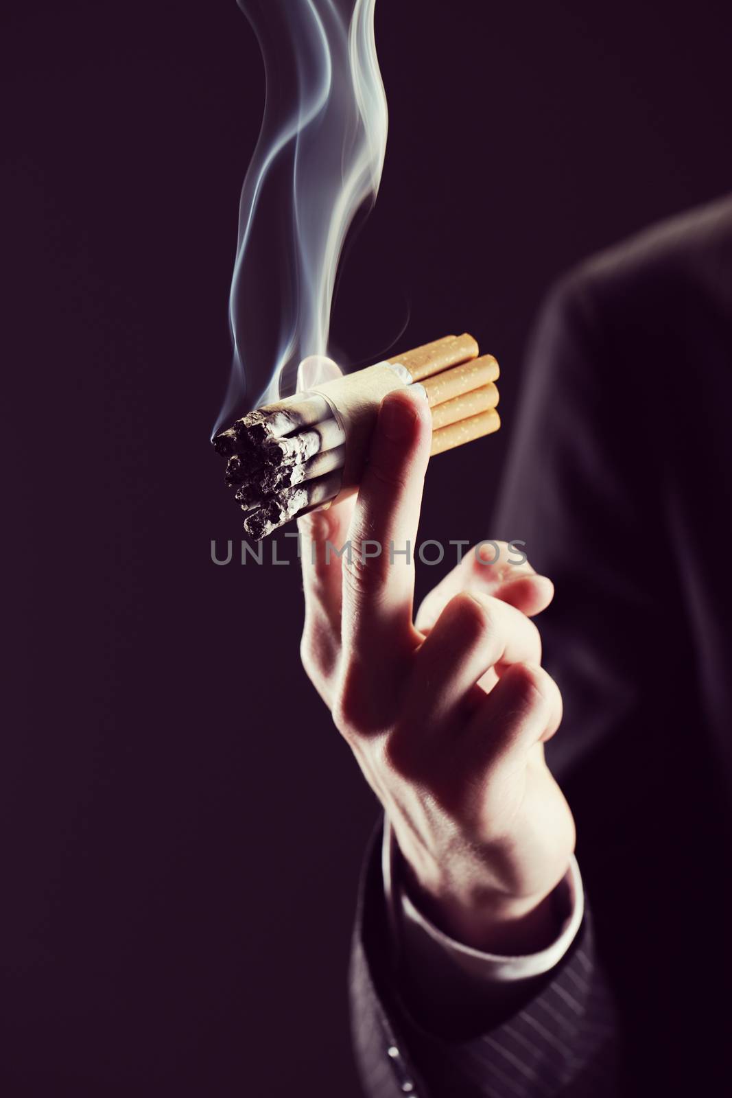 Cropped view of  young man smoking many cigarettes