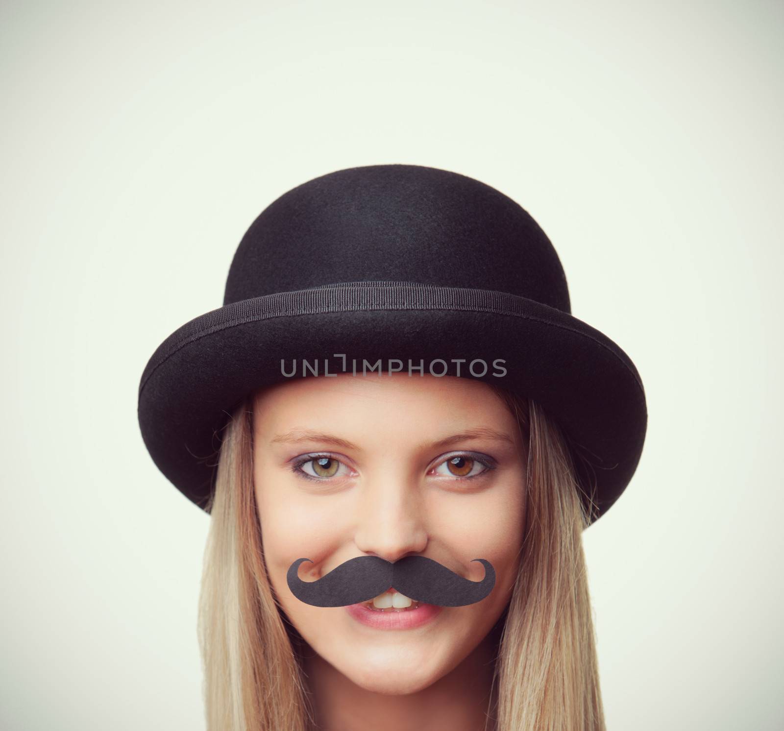 Blonde girl with mustache looking at camera