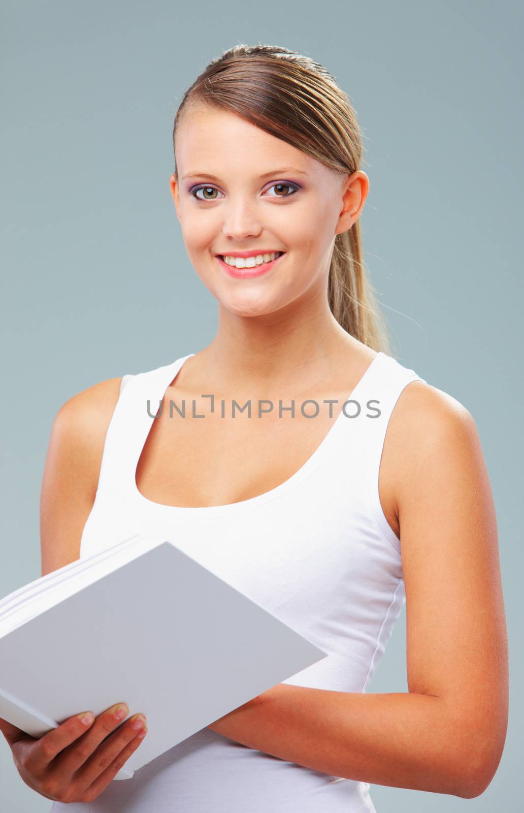 Portrait of beautiful girl holding a white book