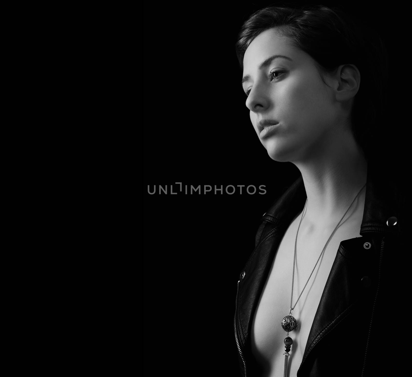 black and white portrait of a beautiful woman with open leather jacket