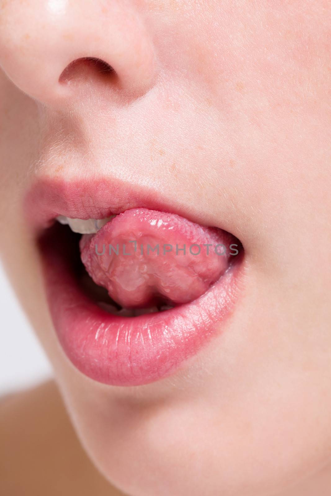 closeup of a beautiful mouth with a tongue licking her lips