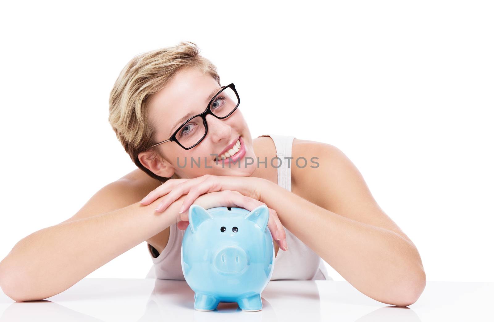 happy woman folding her arms over a piggy bank on white background