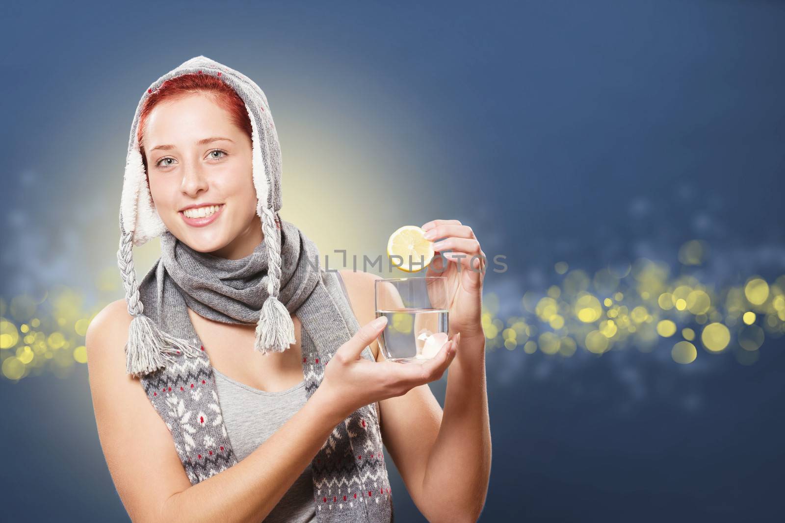 woman adding a healthy lemon to a glass of water