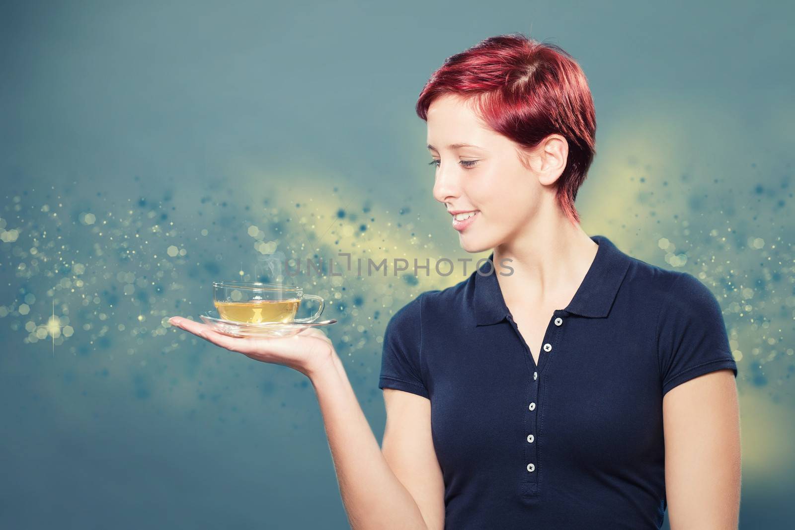 redhead woman holding a cup of yellow tea