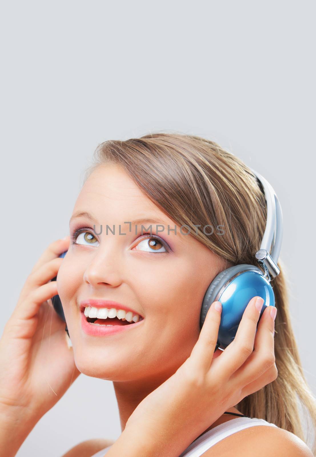 Pretty young woman listening to music on her headphones