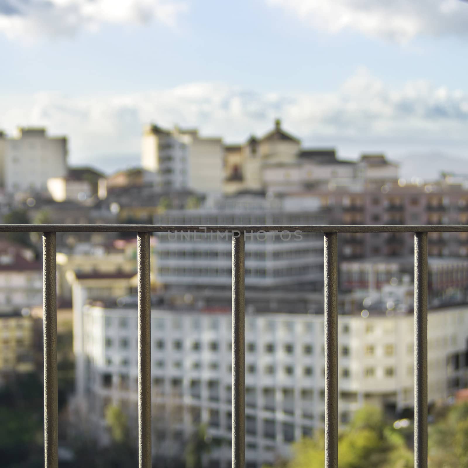 CITY IN THE BACKGROUND, VIEW THROUGH
A RAILING IN THE SPOTLIGHT by propaga