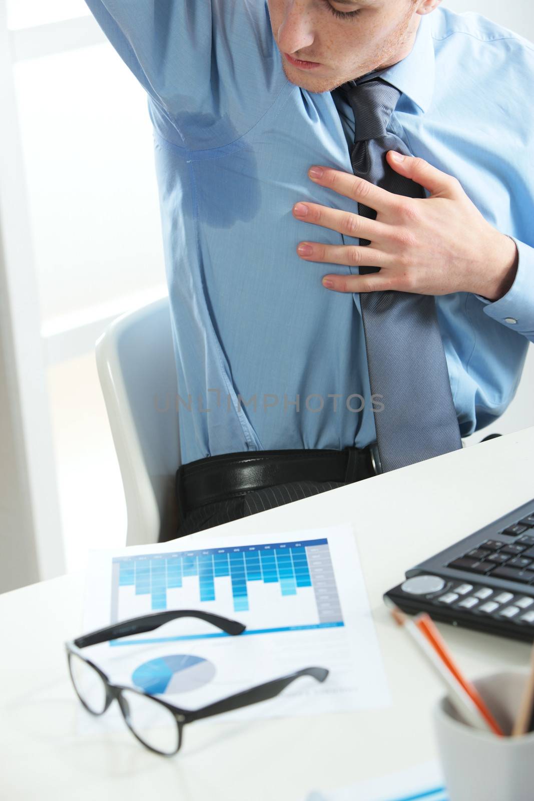 A young business man notices his sweat