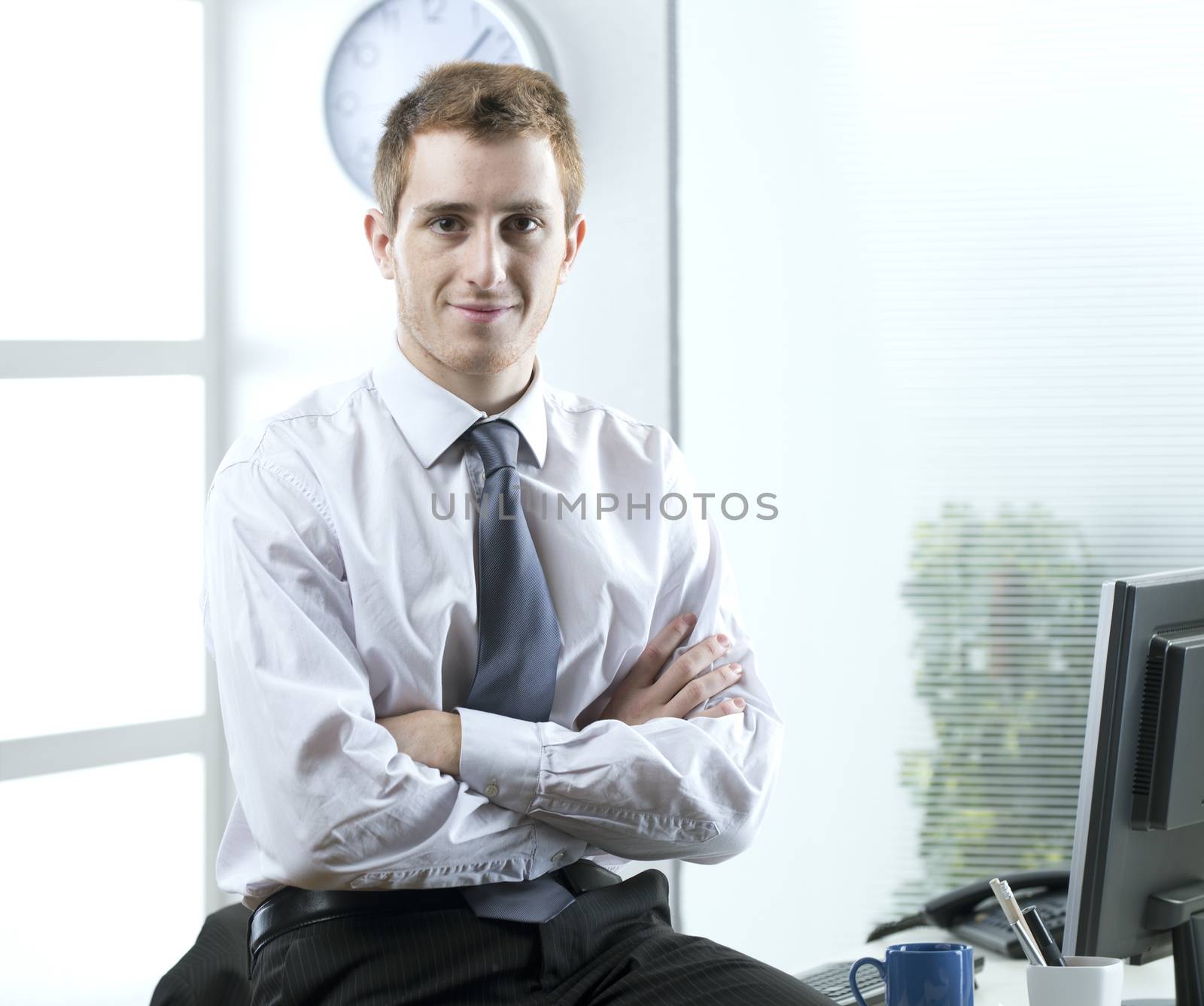 Portrait of young businessman in his office