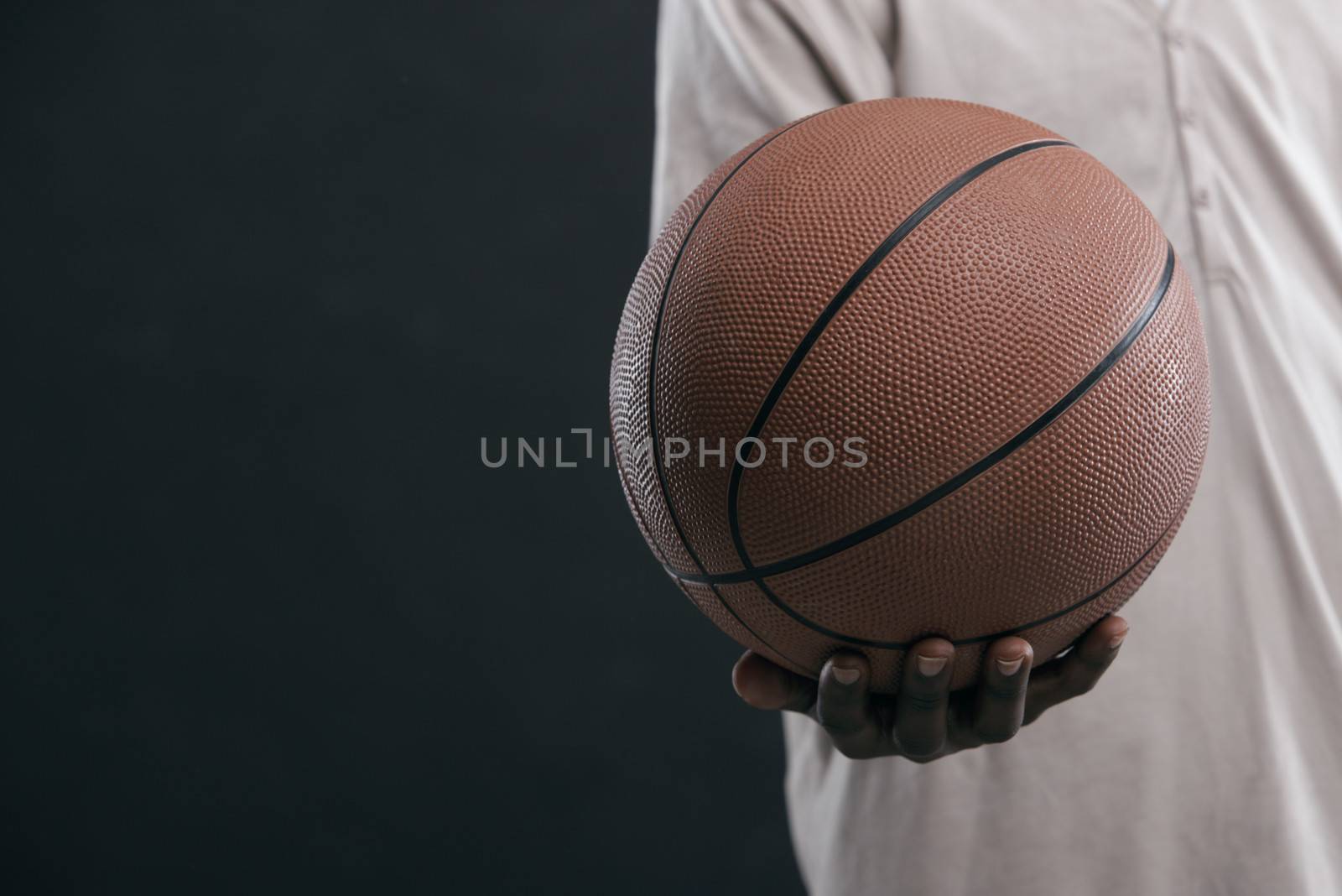 African boy holding a basket ball, hand close up