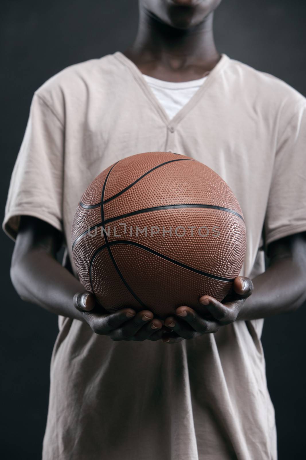Cropped image of African boy holding a basket ball