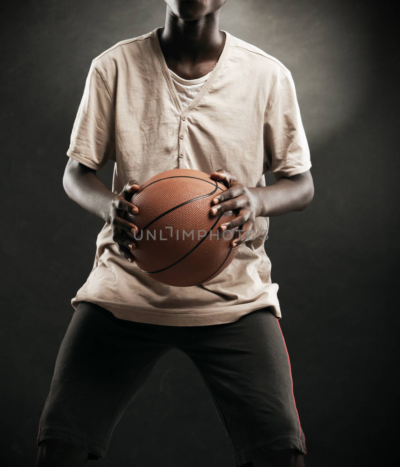 An African boy concentrating to shoot a basketball