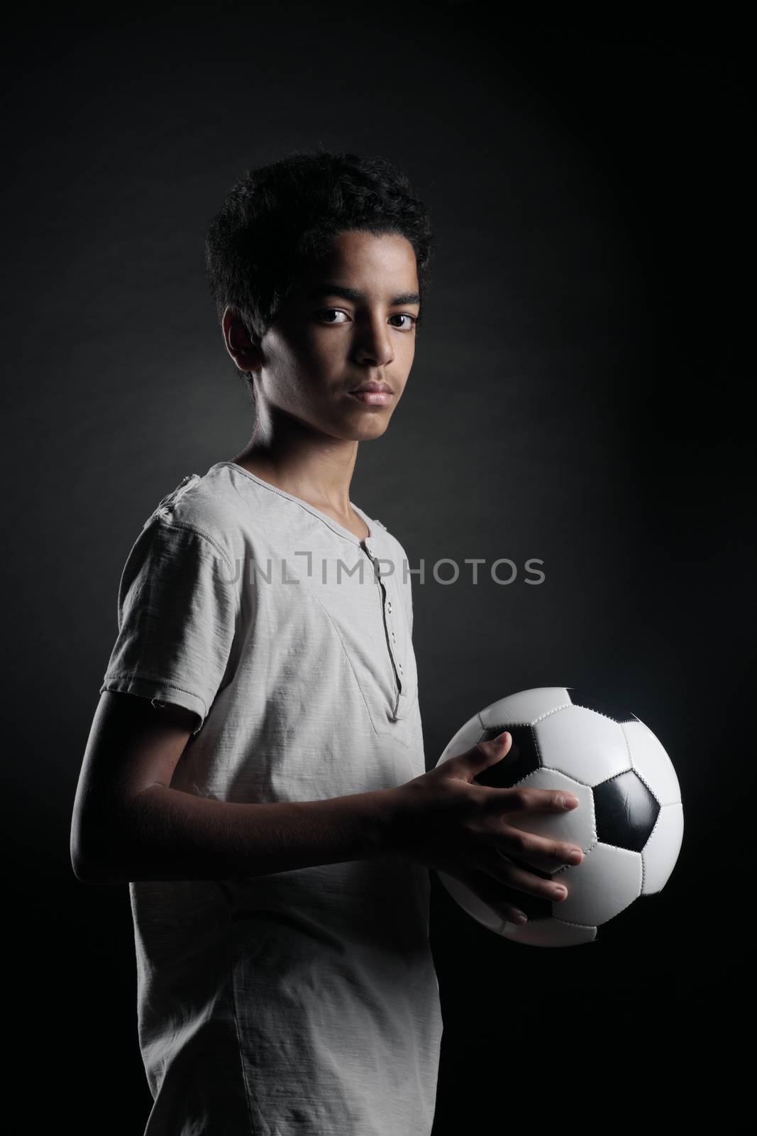 Portrait of young boy with a soccer ball