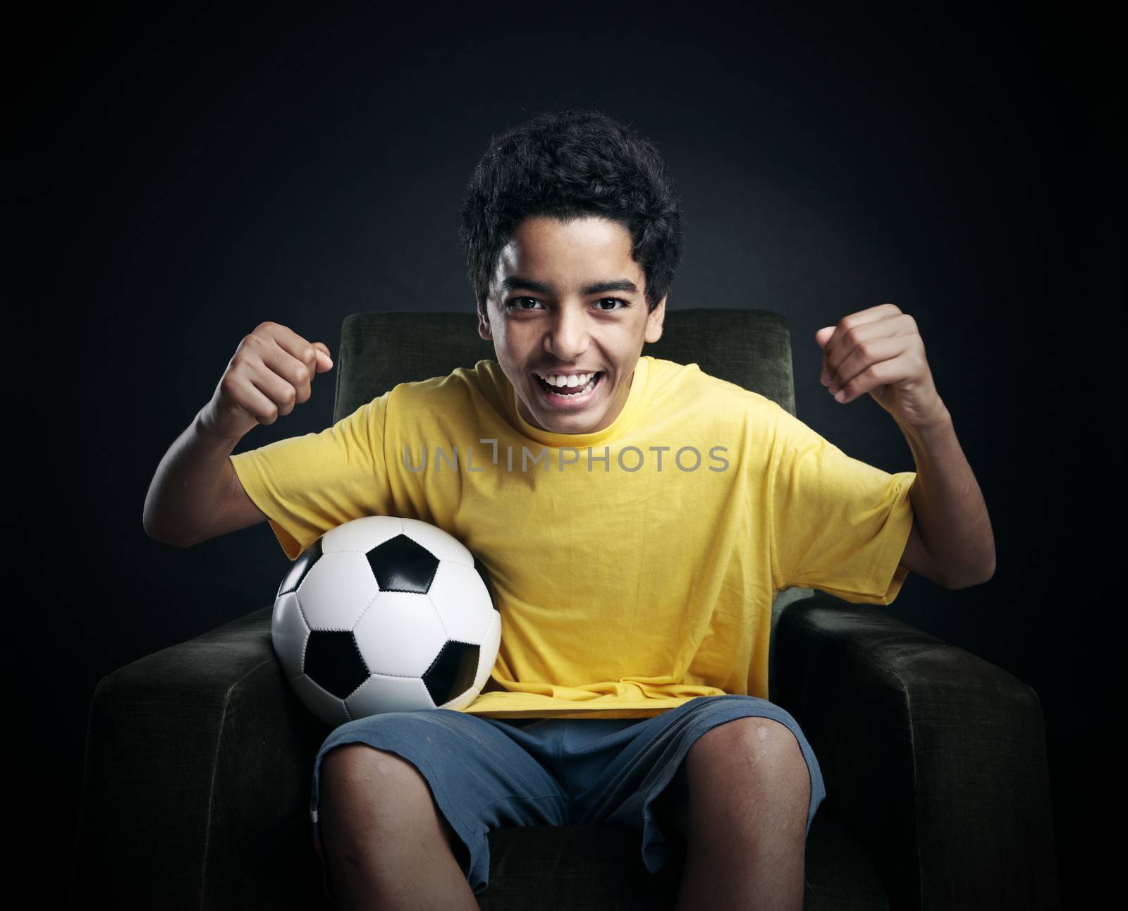 Young boy watching a soccer match on tv