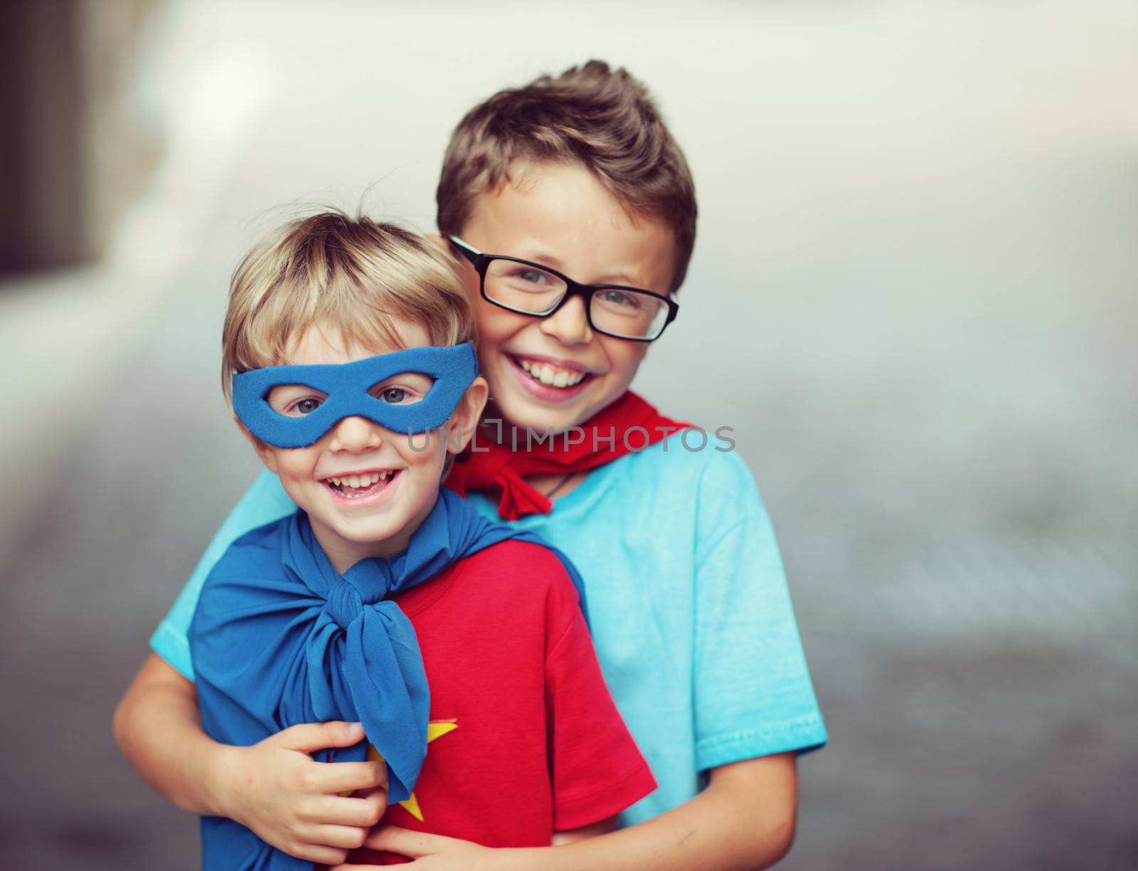 Portrait of two little cheerful superheroes