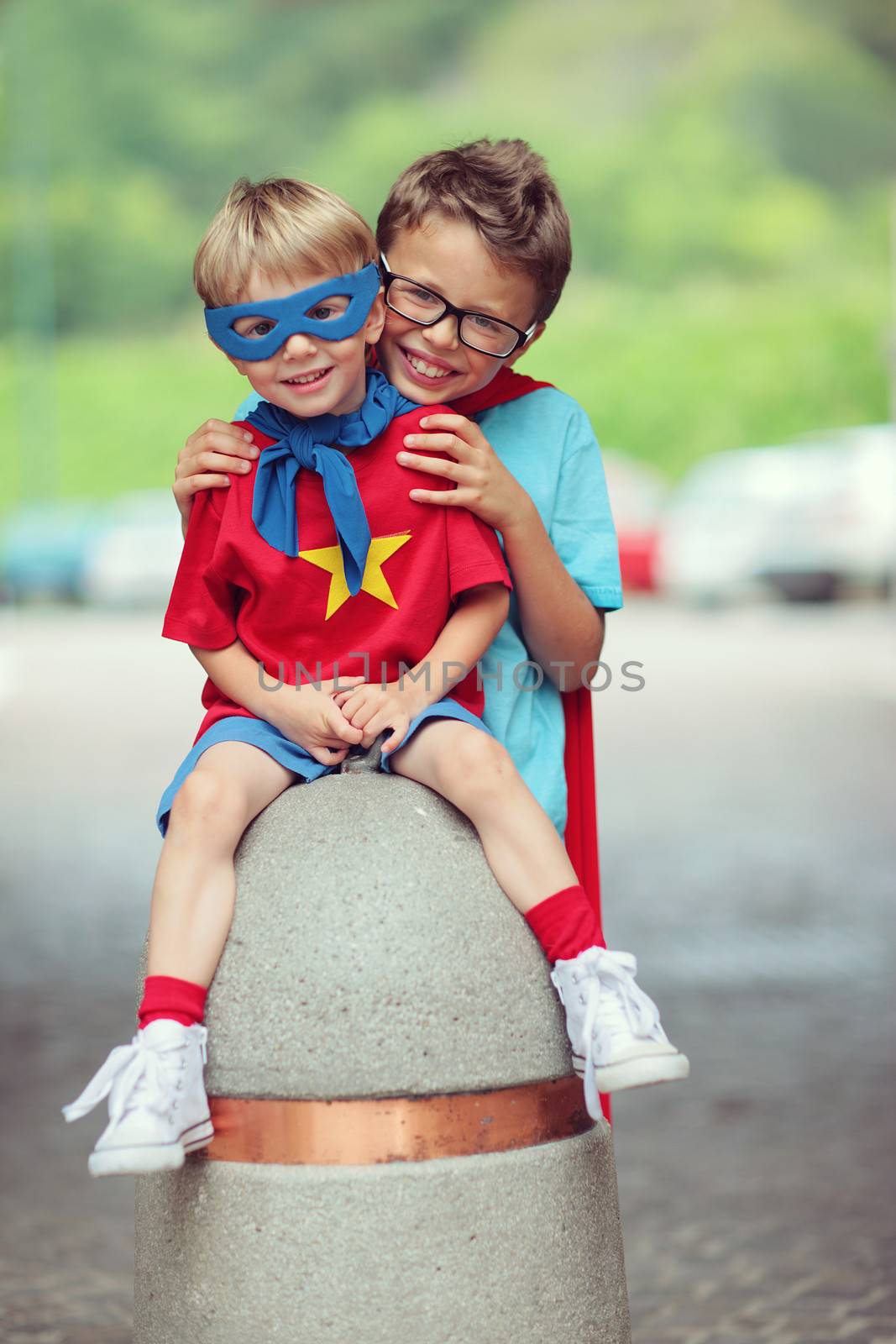 Portrait of two little cheerful superheroes