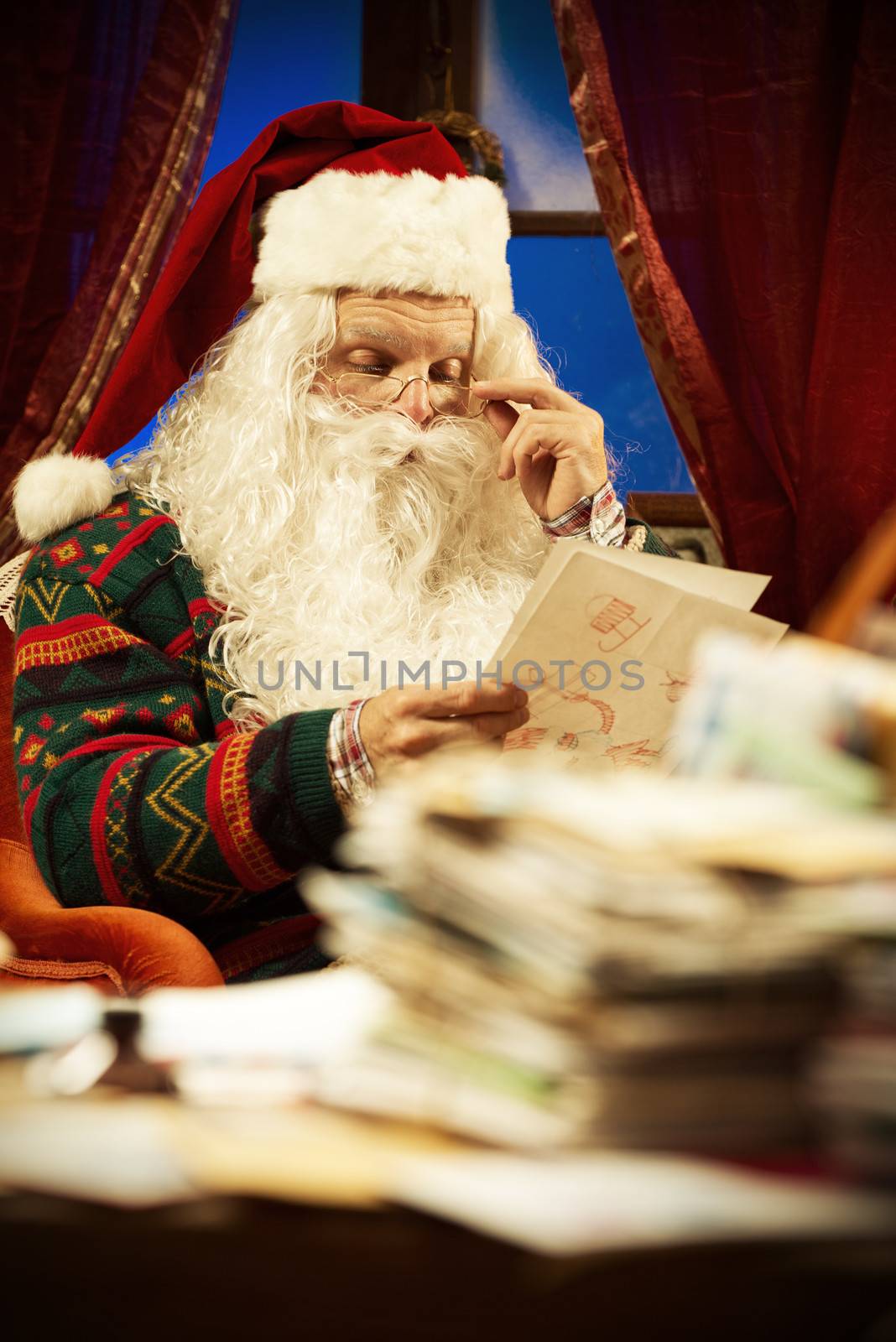 Portrait of Santa Claus reading a Christmas letter
