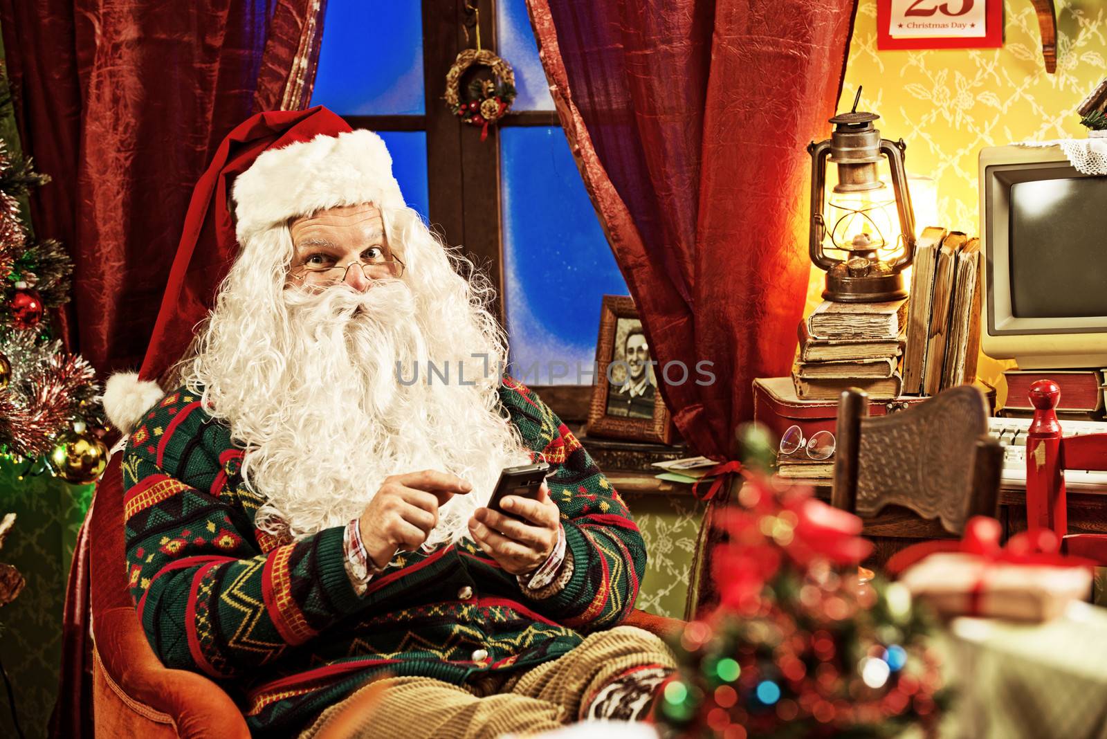 Portrait of Santa Claus using his new smartphone 