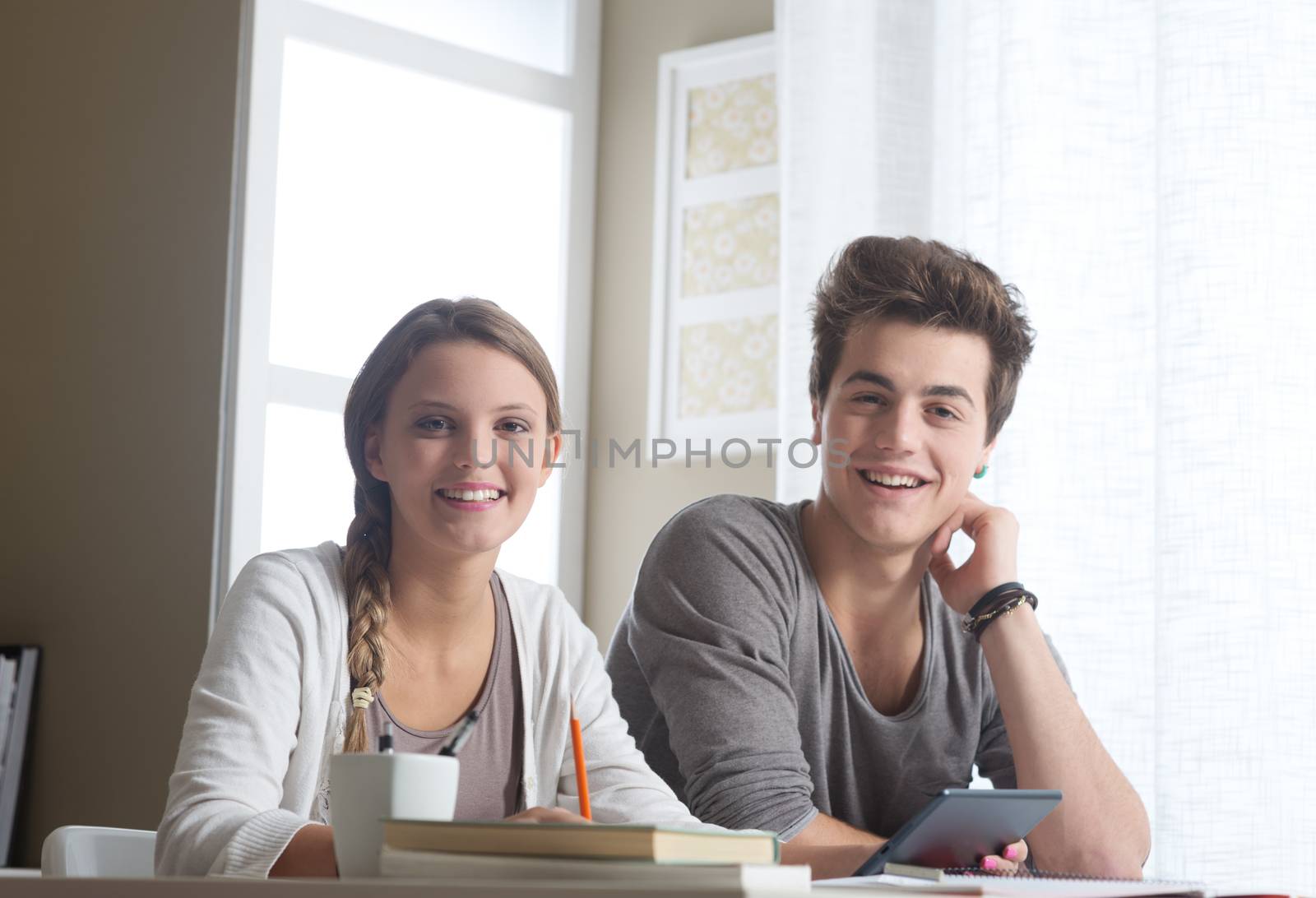 Portrait of two young students at home