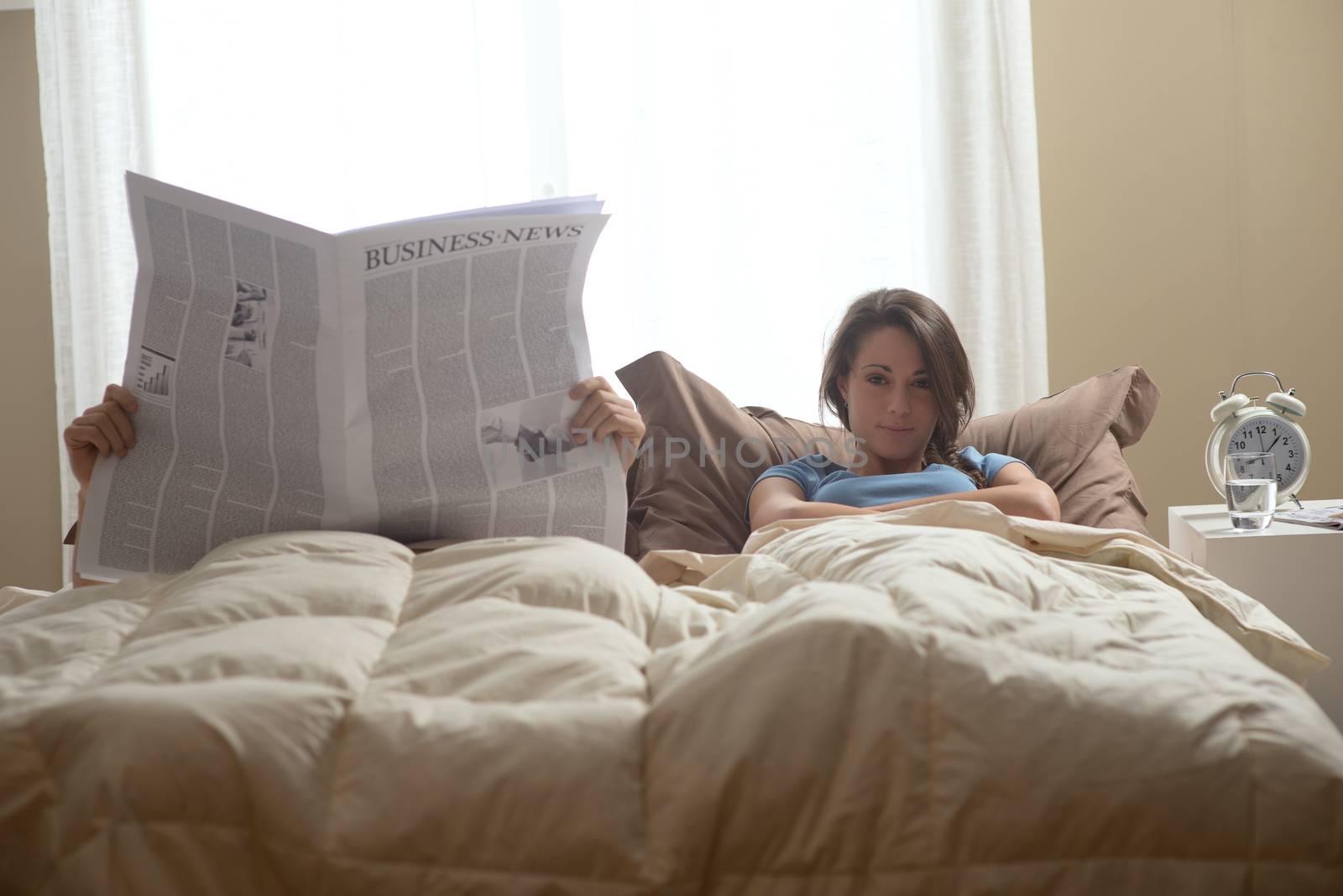 Man reading a newspaper while her wife waiting...