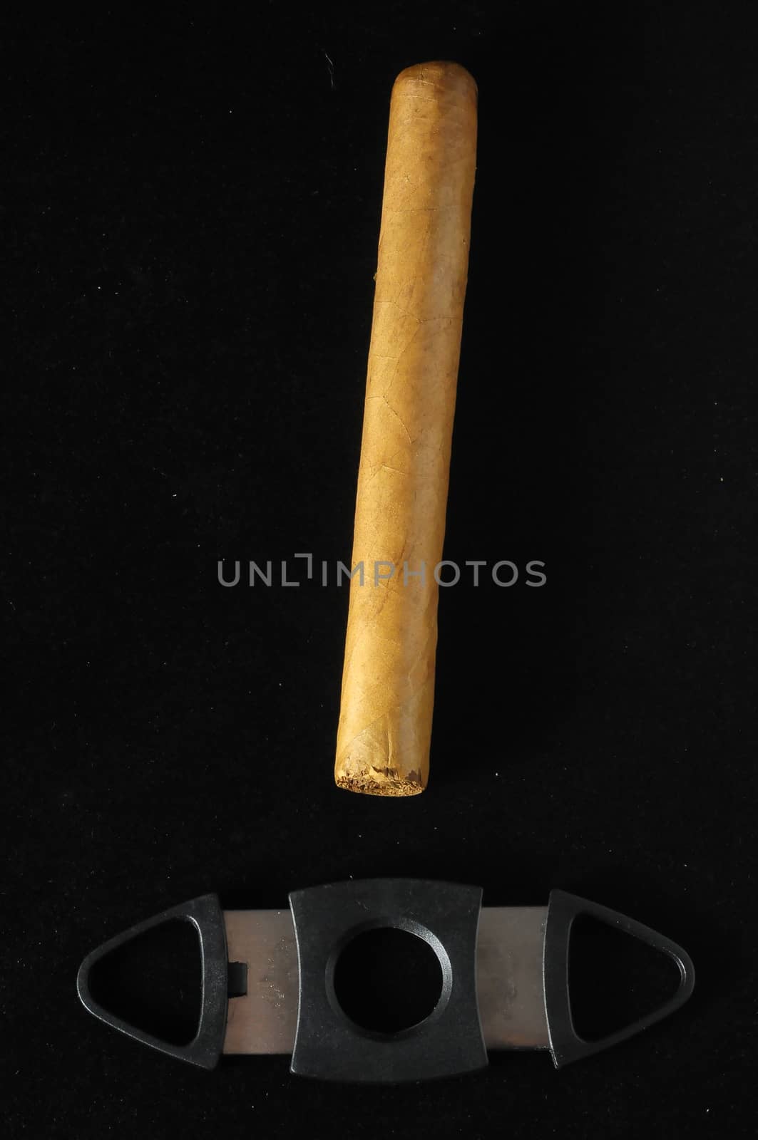 Cuban Brown Havan Cigar and Cutter on a black background