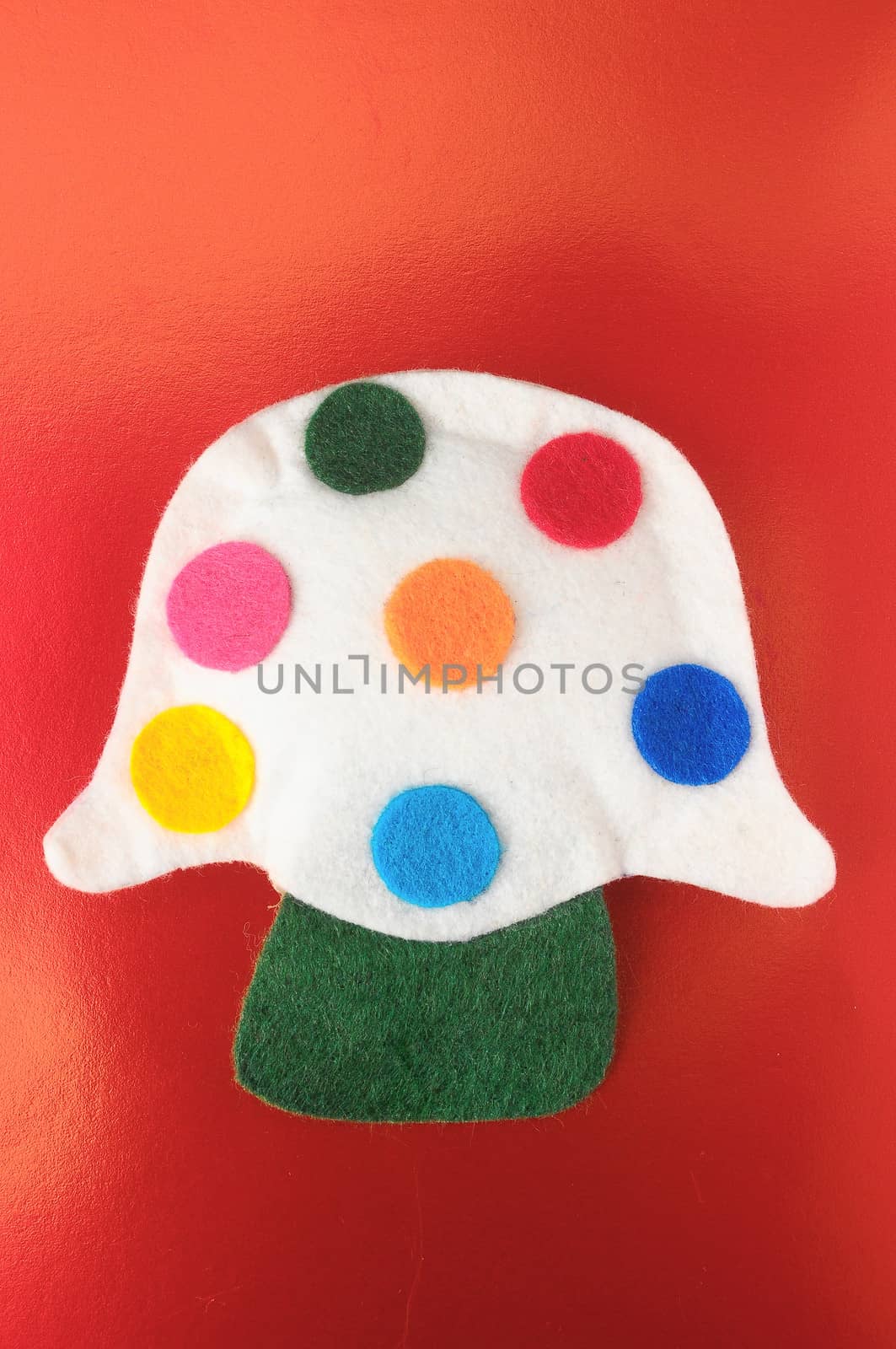 Cloth Multicolored Magic Mushroom on a Colored Background