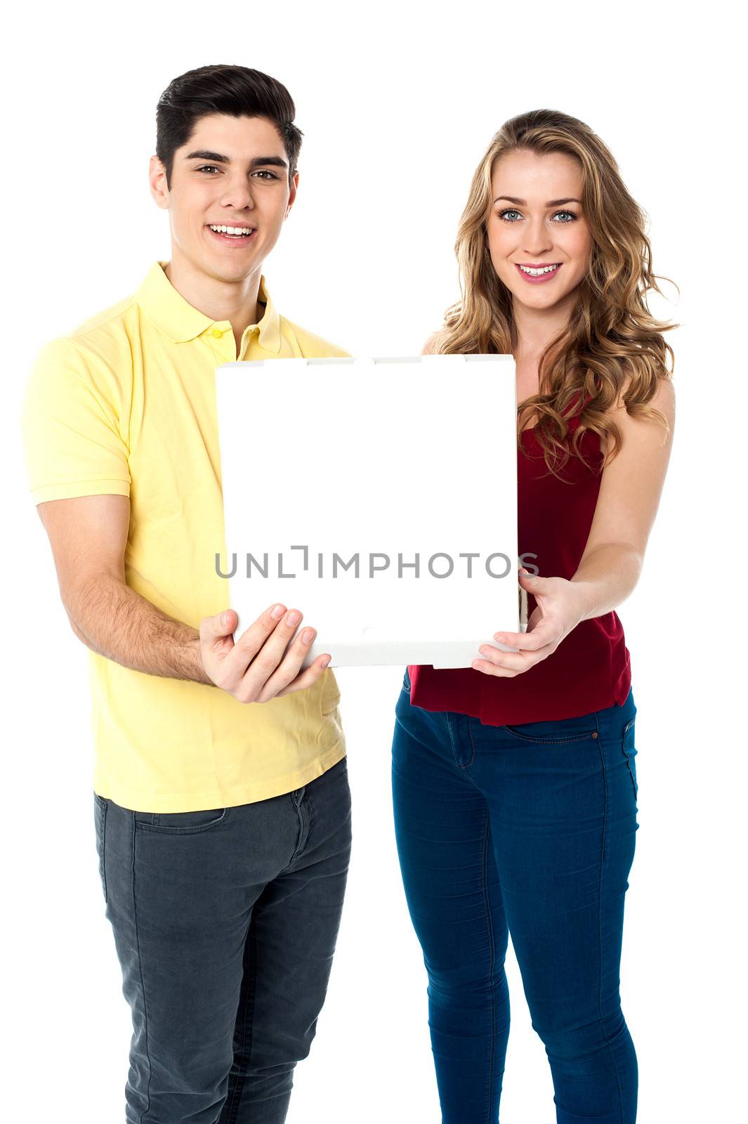Young love couple with pizza box by stockyimages