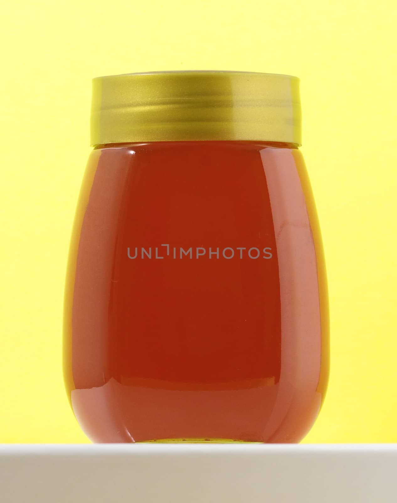 One Full Honey Jar on a Colored Background