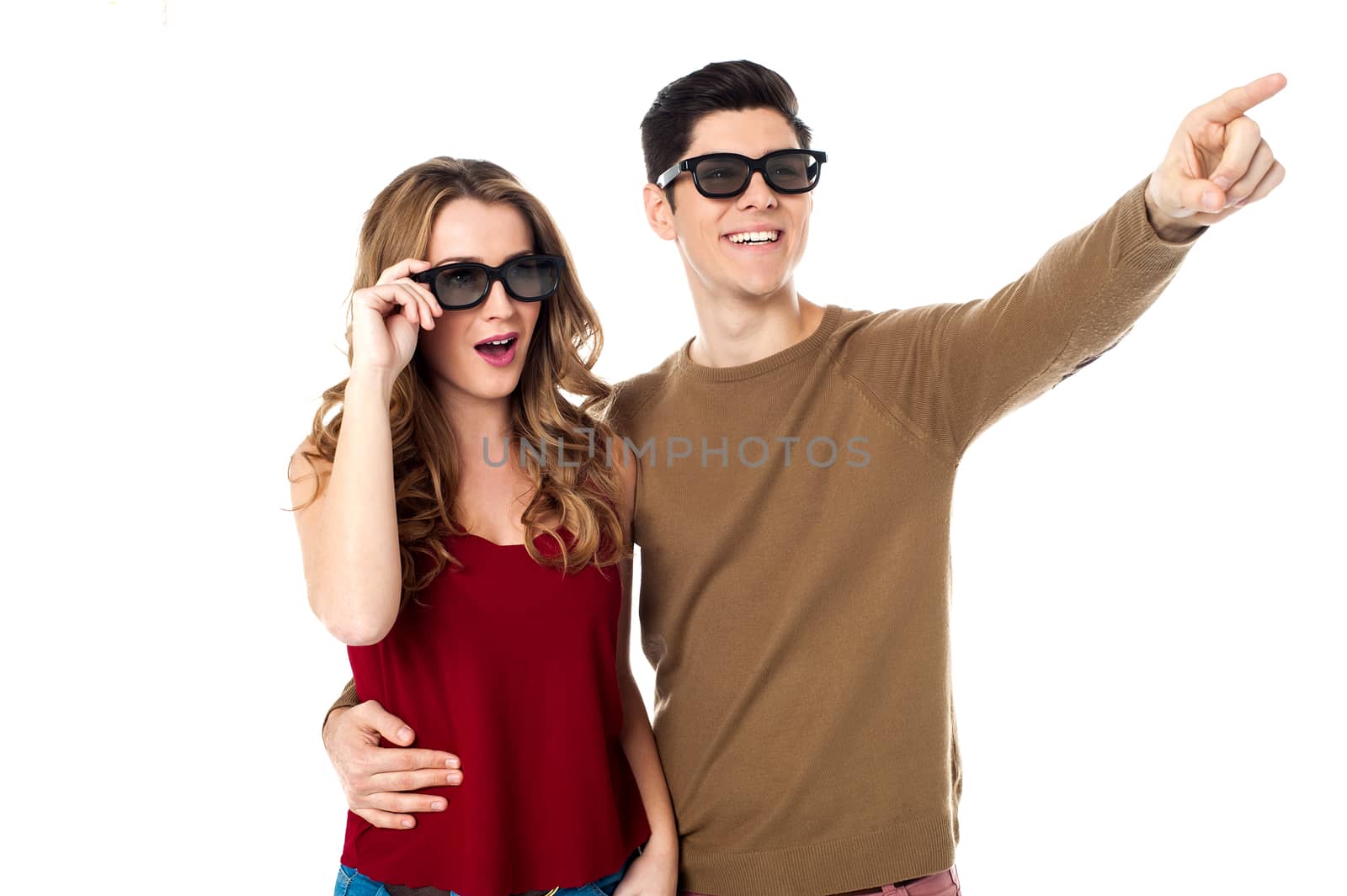 Boy embracing his girl and pointing away